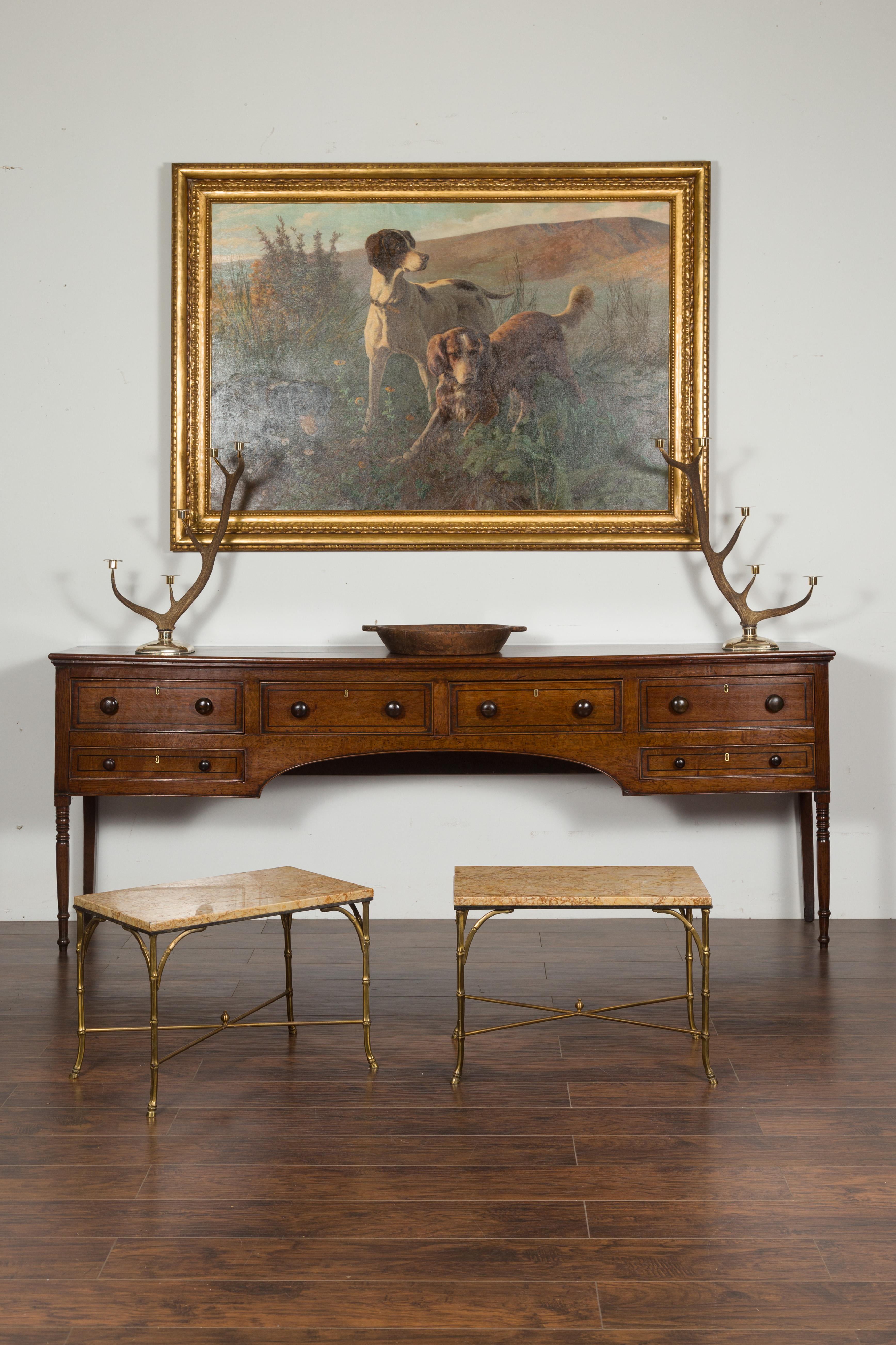 A pair of vintage European bronze faux-bamboo low side tables from the mid-20th century, with marble tops. Created during the midcentury period, each of this pair of bronze side tables features a rectangular marble top sitting above four faux-bamboo