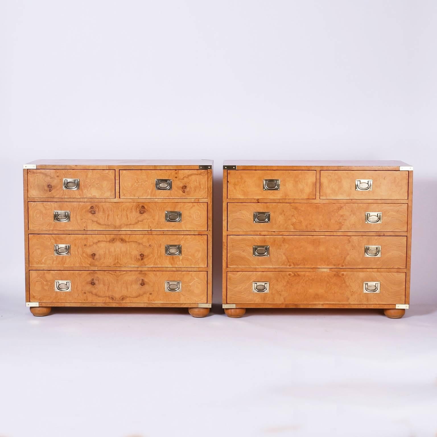 Distinctive pair of campaign style chests with exotic bleached, burled
walnut veneers, campaign style brass hardware and classic bun feet.
Signed Henredon in a drawer.