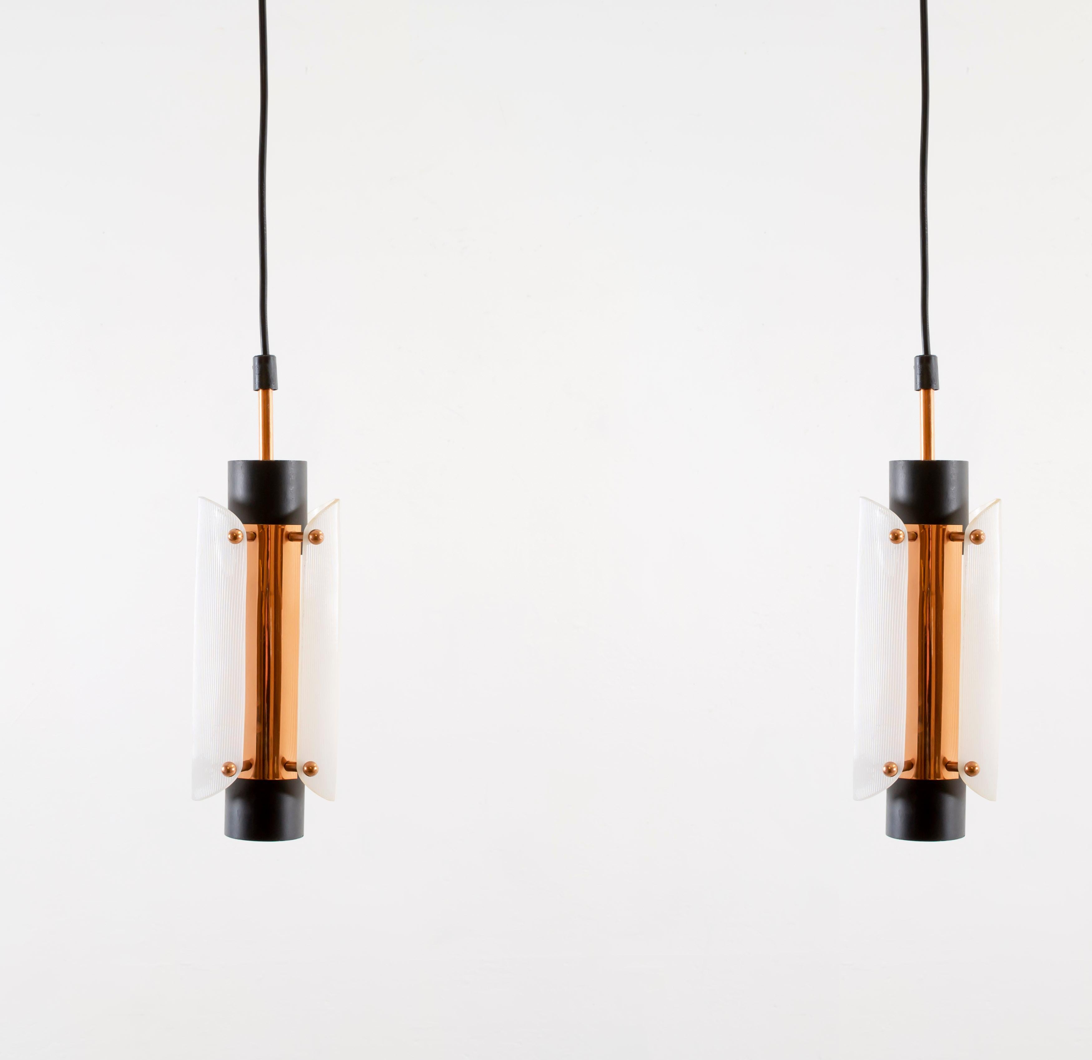 Sublime pair of ceiling pendants in painted steel, copper and plexiglass. Designed and made in Denmark from circa 1960s second half. Both lamps are fully working and in very good vintage condition. Max 40W, E14 bulbs.