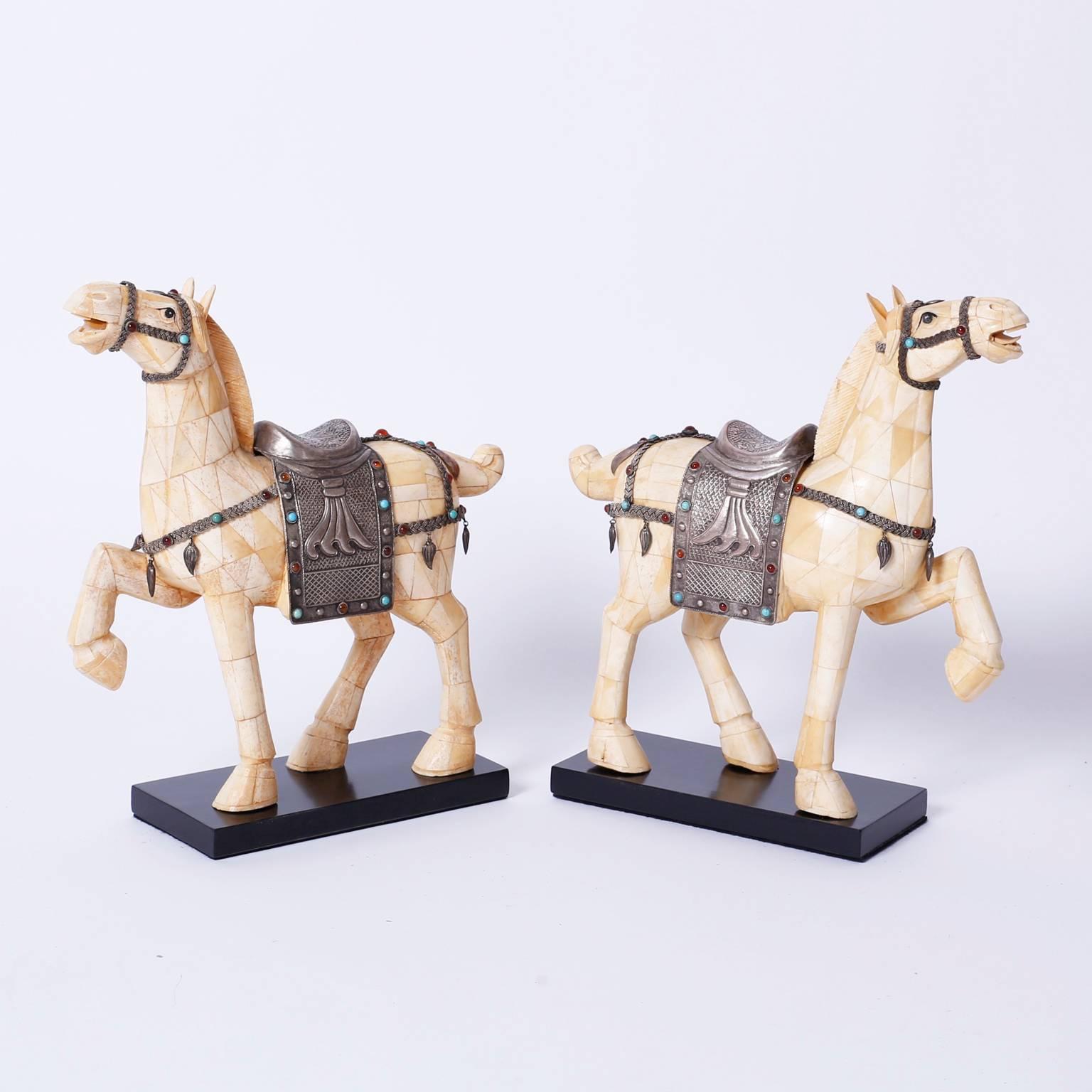 Dapper pair of Chinese horses crafted in a mosaic of bone having hand-hammered
silvered metal saddlery decorated with semi precious stones.
Classic form in the tradition of the Tang dynasty.