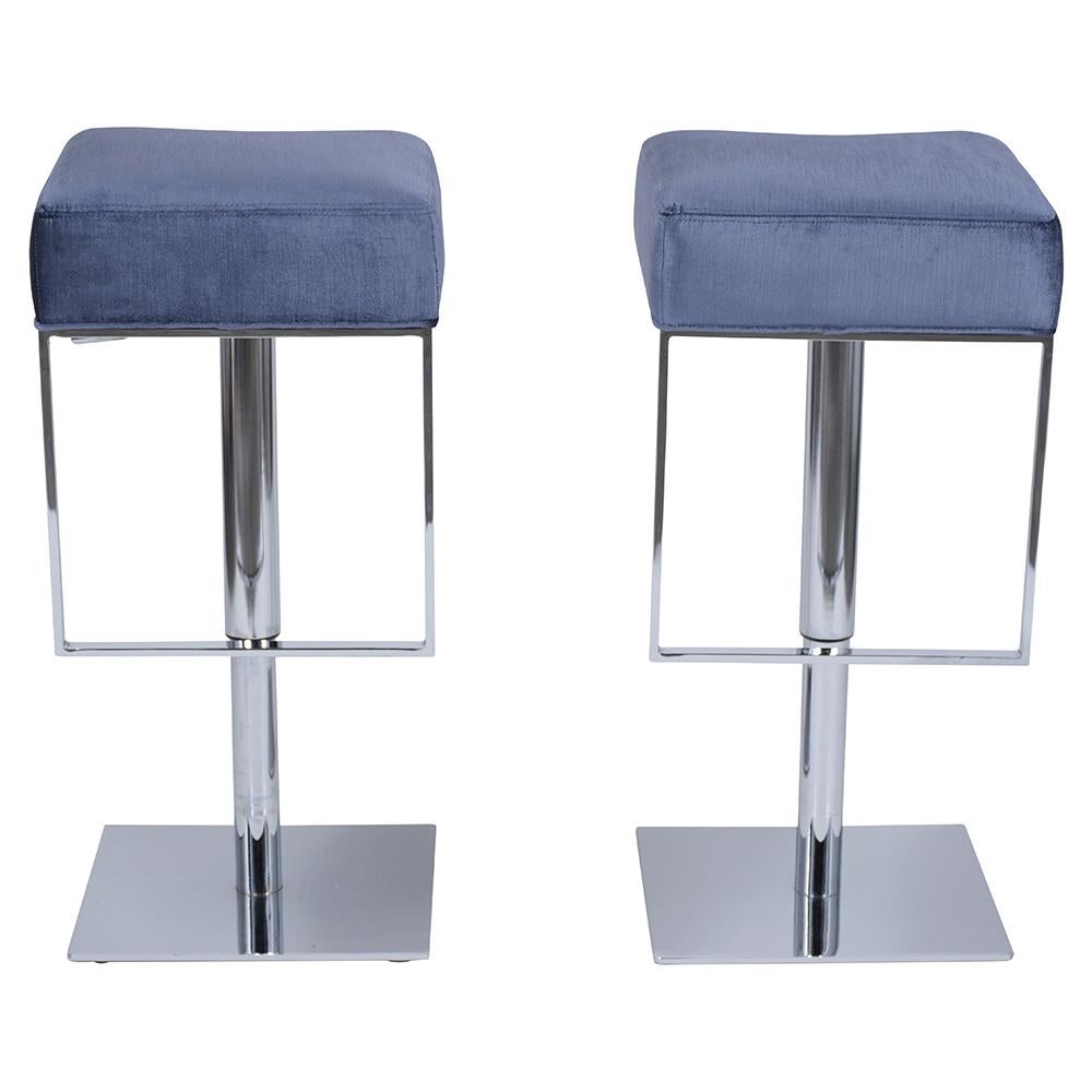 Introducing our pair of mid-century swivel bar stools, a perfect blend of sleek design and functionality. These stools feature solid steel bases, ensuring sturdiness and longevity. They're in excellent condition, showcasing the timeless appeal of