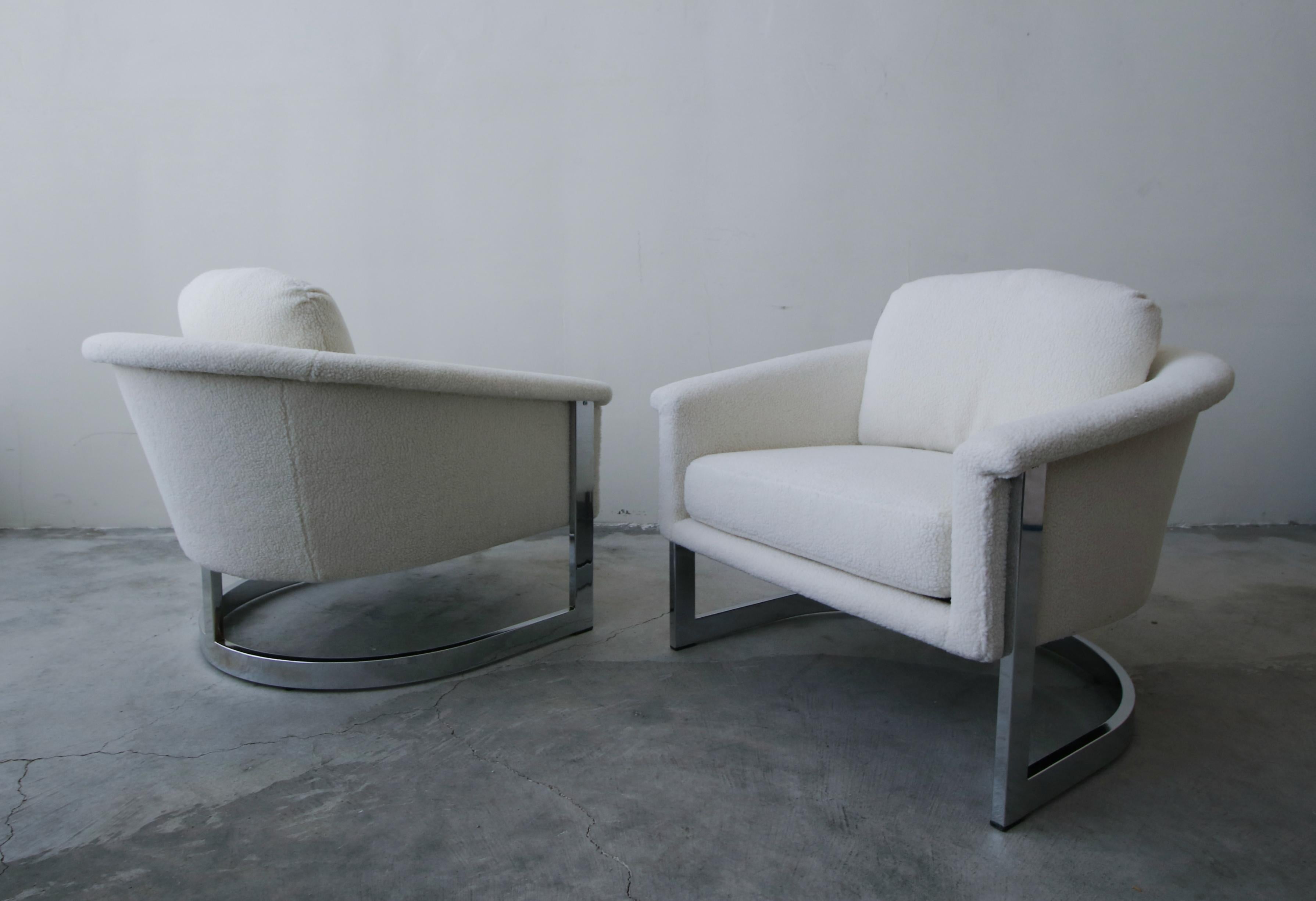 Exquisite pair of midcentury chromed steel, cantilever lounge chairs by Selig. They have a beautiful profile. The beautiful chrome frames cradle the chairs. 

Chairs have been professionally restored with all new foam and faux Sherpa fabric. The