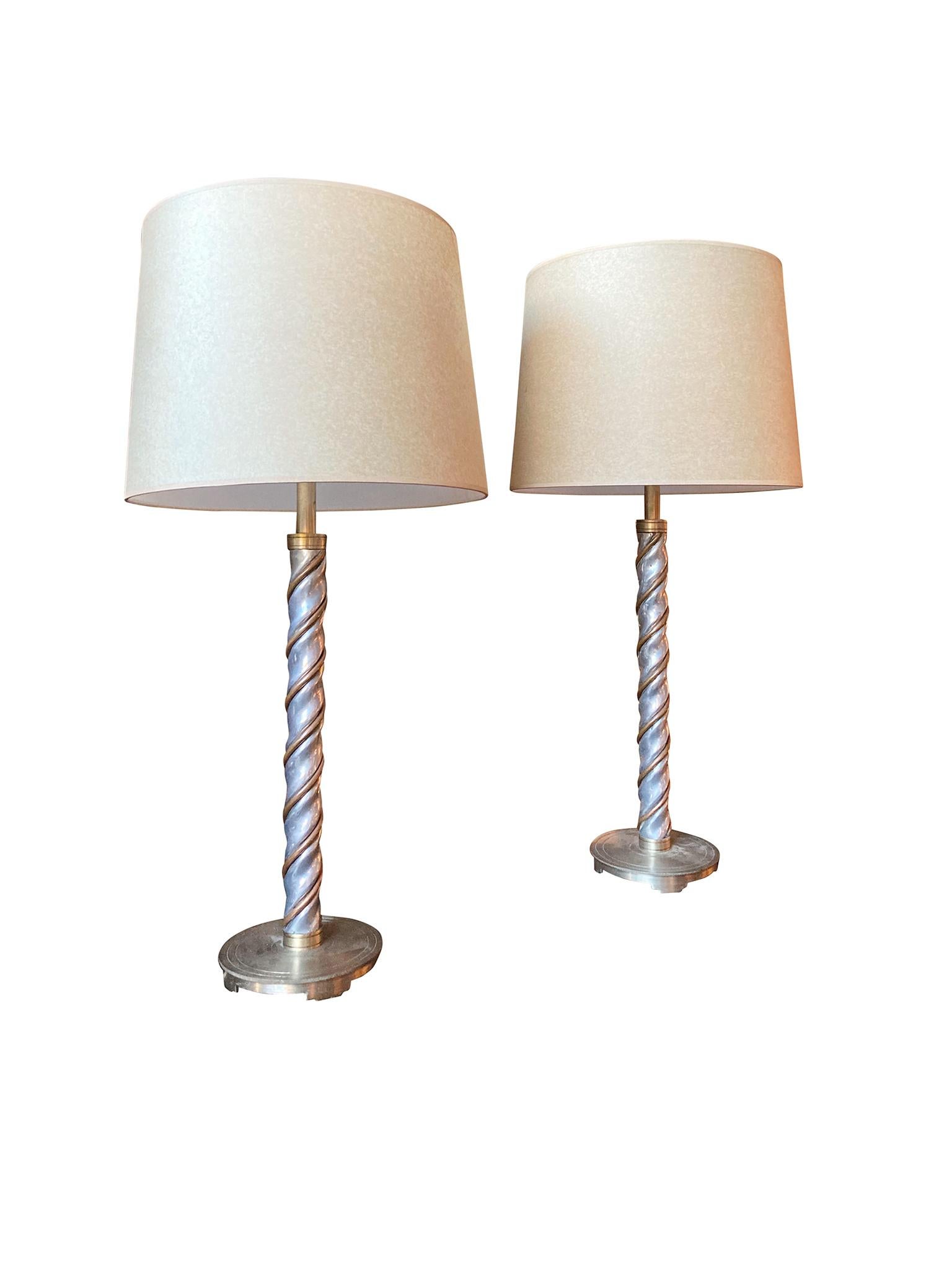 Pair of midcentury Art Deco style table lamps with copper and chrome. We love how these two metals are combined in a braided design mounted on a brass disc base. The lamps have double cluster bulb sockets with pull threads and are newly rewired.