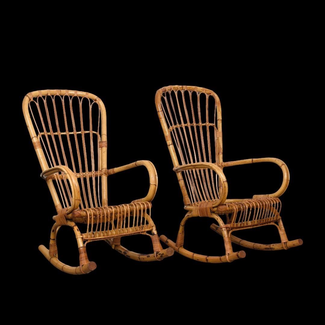 Pair of elegant midcentury French Riviera rattan and bamboo rocking chairs. This fantastic set was designed and manufactured in Italy during the 1960s.

The chair has a solid rattan seat with a bamboo frame, with beautiful details, such as bamboo