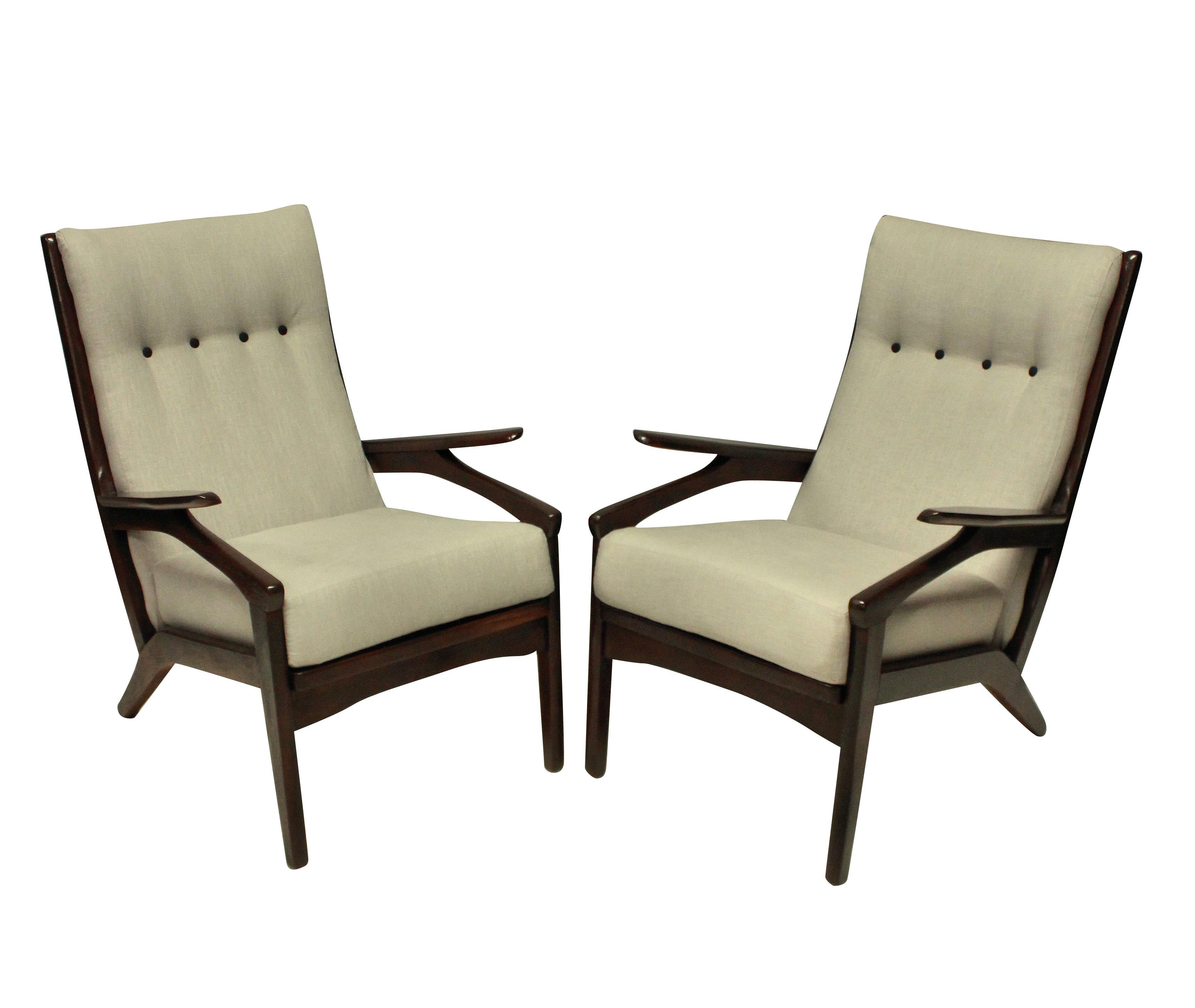 A pair of midcentury Danish armchairs in stained teak, which is a dark walnut in color. Newly upholstered in plain linen.