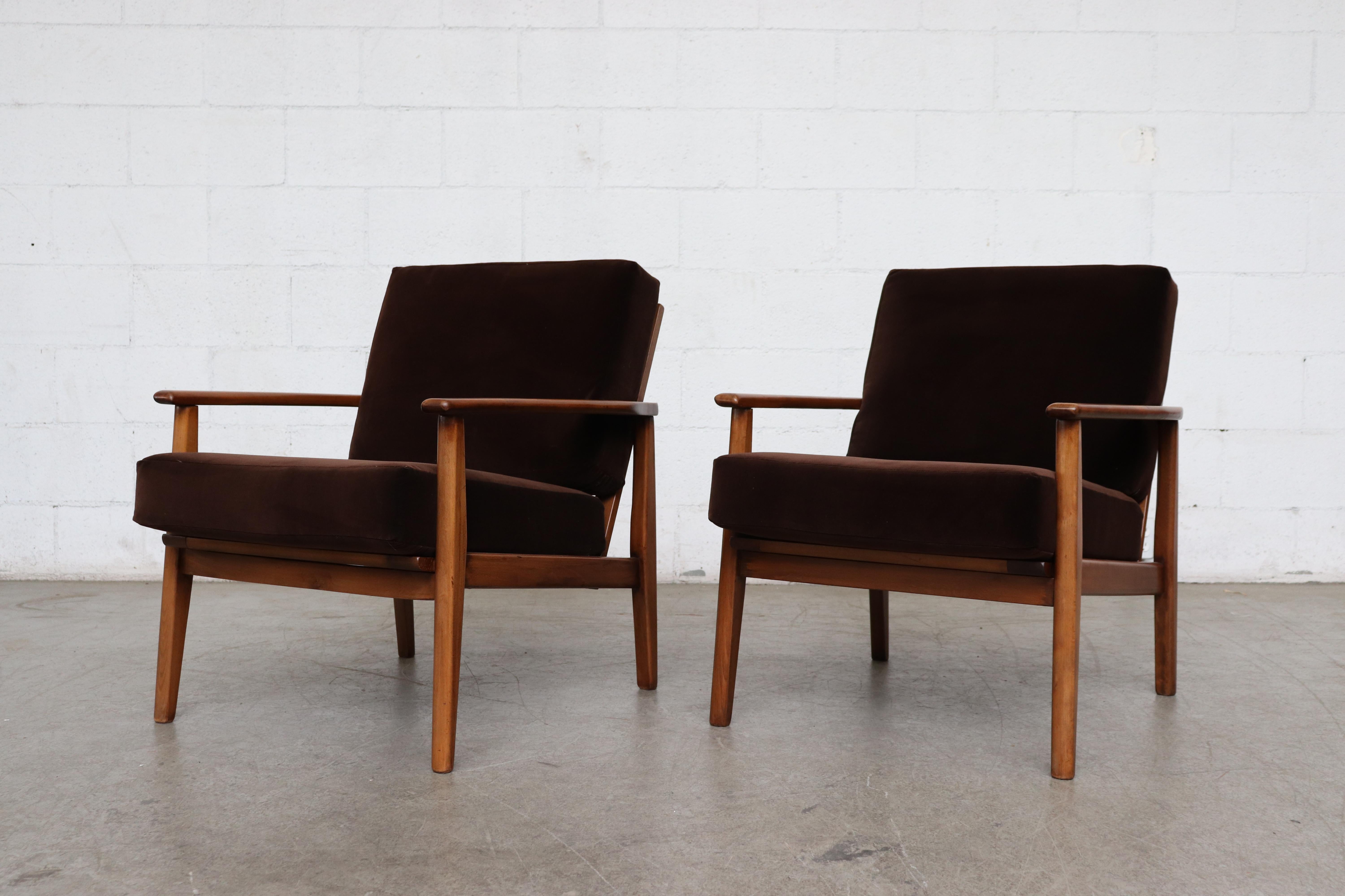 Pair of Danish midcentury lounge chairs with beautiful lightly refinished teak frames and newly upholstered dark chocolate velvet cushions. Good original condition, set price.