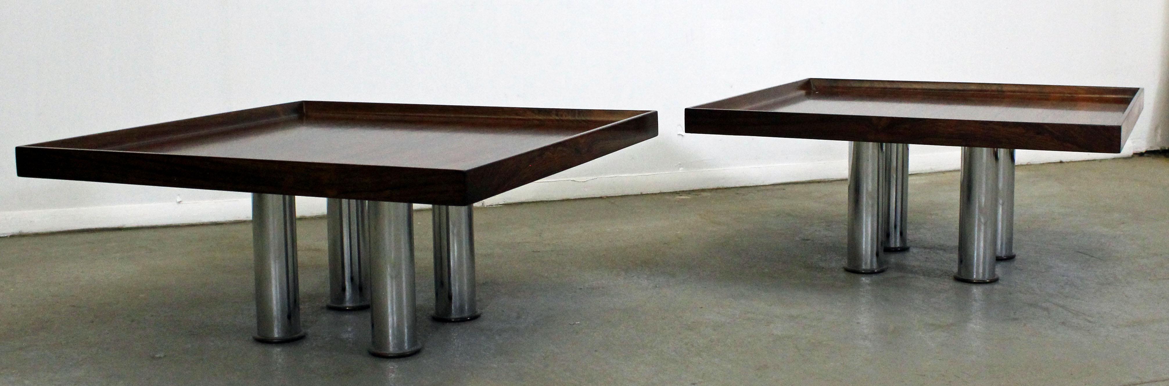 Offered is a pair of Mid-Century Modern coffee tables. Feature square tops and four chrome legs each. They are in excellent condition for their age, shows some slight wear (patina on chrome, minor surface wear-see photos). They are unsigned. A great