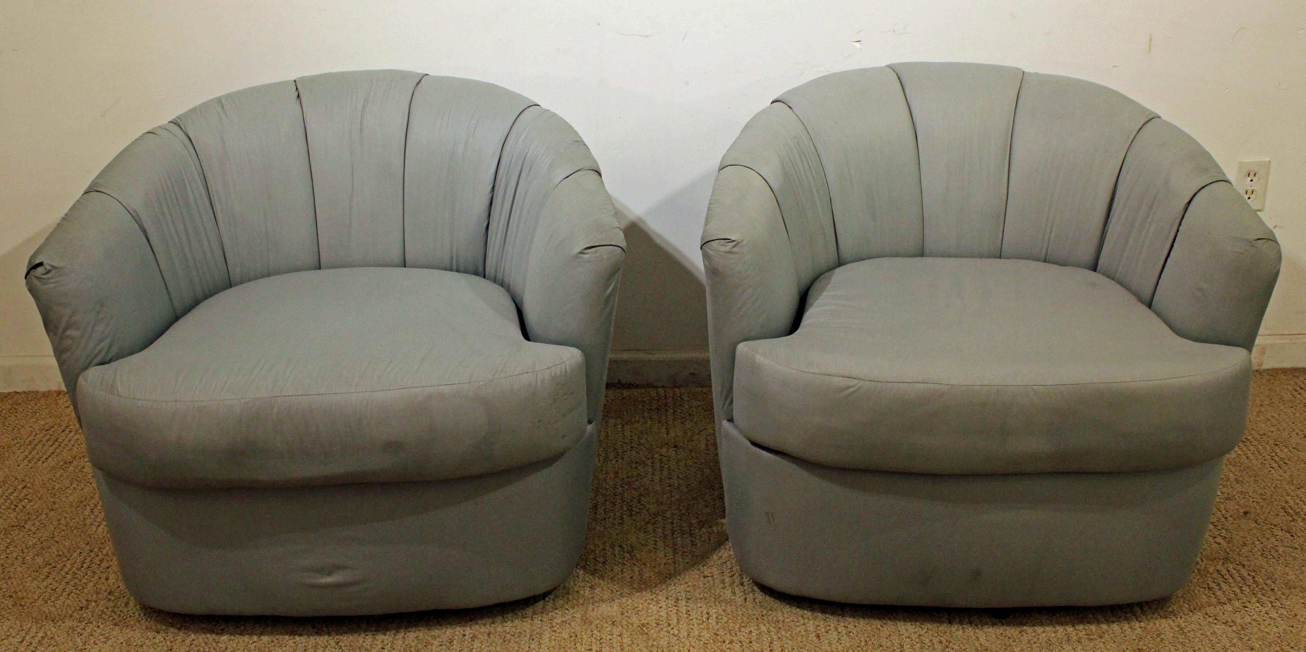 Offered is a pair of Mid-Century Modern swivel chairs. They were designed for Selig. They are in decent condition, but need to be reupholstered, showing age wear (minor tears, stains, age wear-see pics). They are signed by Selig.

Dimensions:
31