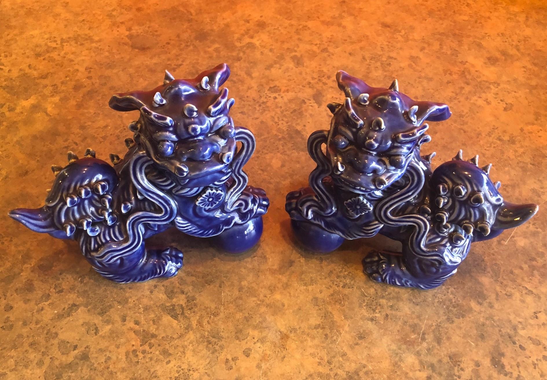 A very nice pair of midcentury Chinese ceramic foo dogs in a dark blue glaze, circa 1960s. Excellent condition and patina; makes a great pair of book ends or a fun decor item in any room!