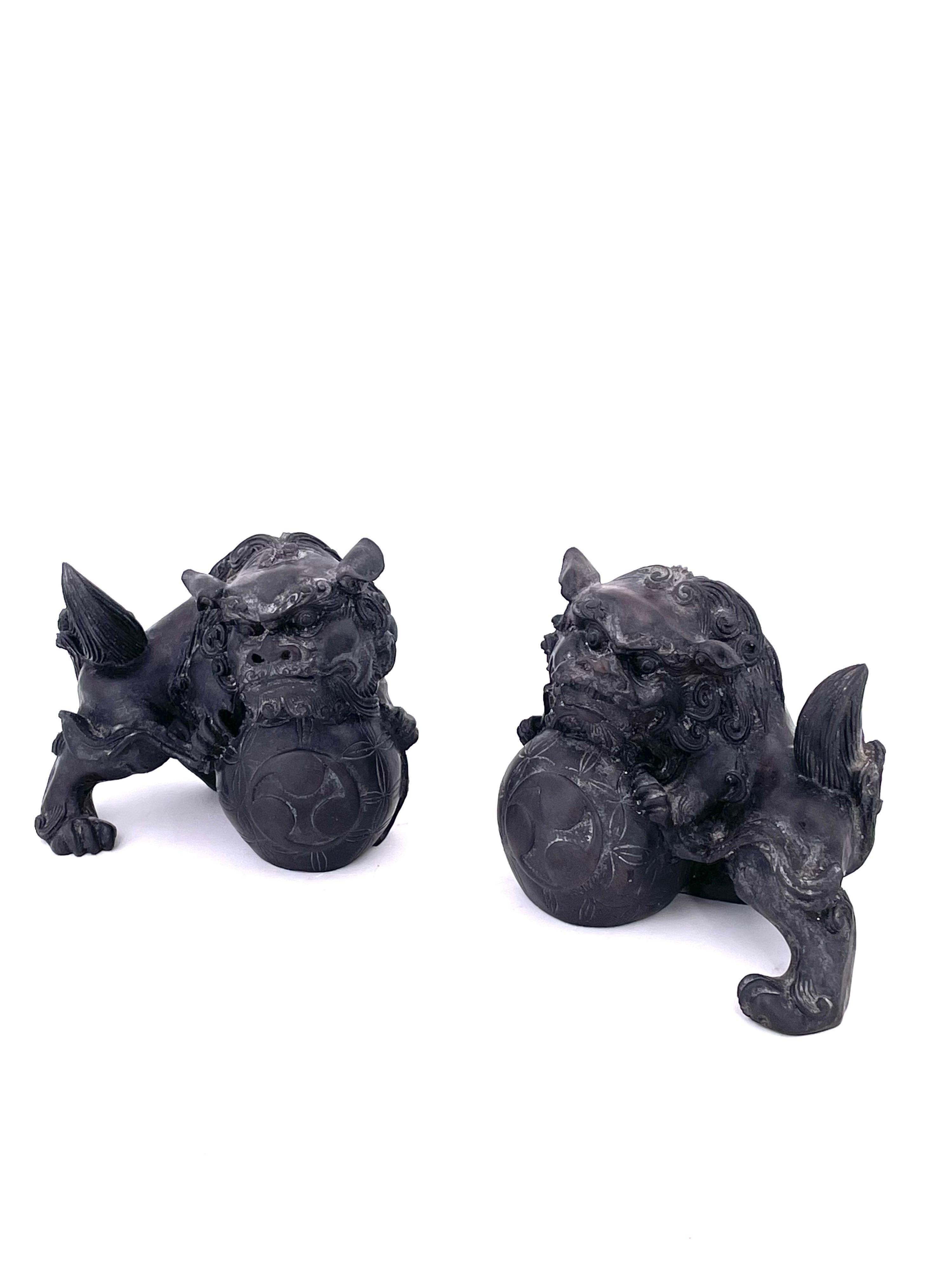 A very nice pair of midcentury Chinese resin foo dogs in a dark blue-grey finish, circa 1960s. Excellent condition and patina; makes a great pair of bookends or a fun decor item in any room!