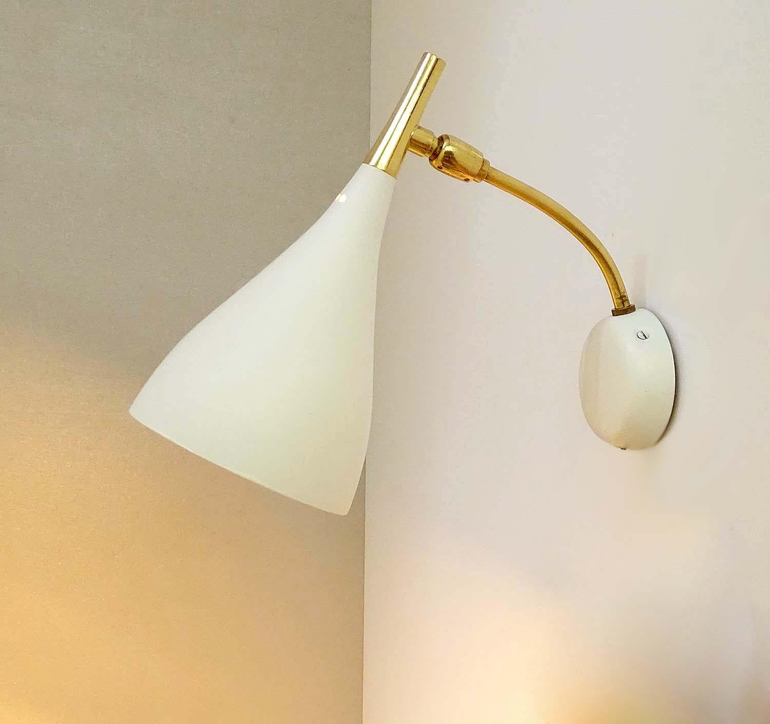 Pair of midcentury wall sconces,  diabolo shades on brass structure, the shades angle can be adjusted
Dimensions:
H 8.67 in. x W 4.34 in. x D 6.3 in.
H 22 cm x W 11 cm x D 16 cm
One candelabra bulbs up to 40 watts each.