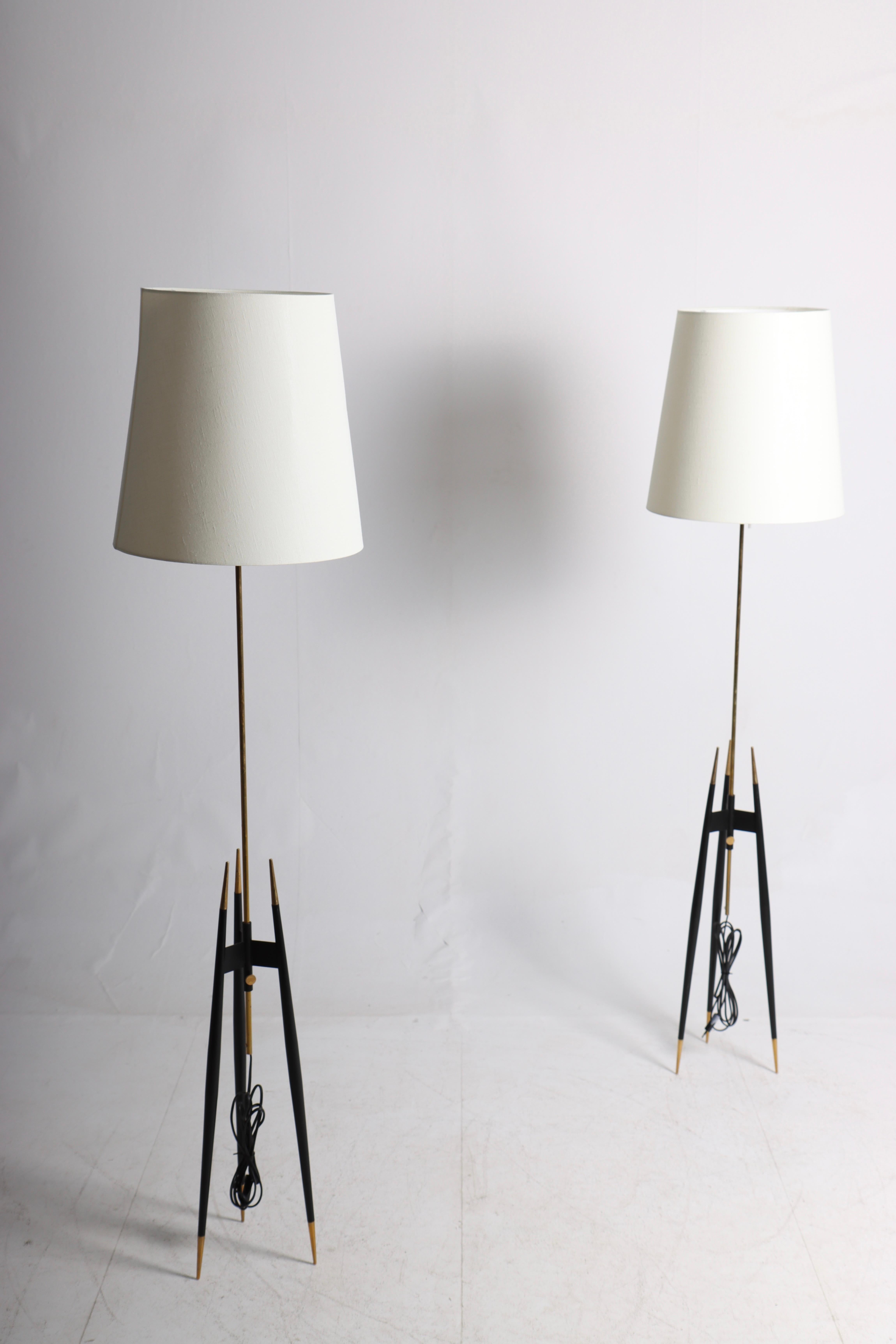 Pair of great looking floor lamps with adjustable height in black painted metal and brass. Designed and made by S. A. Holm Sørensen in the mid-1950s. Great original condition.