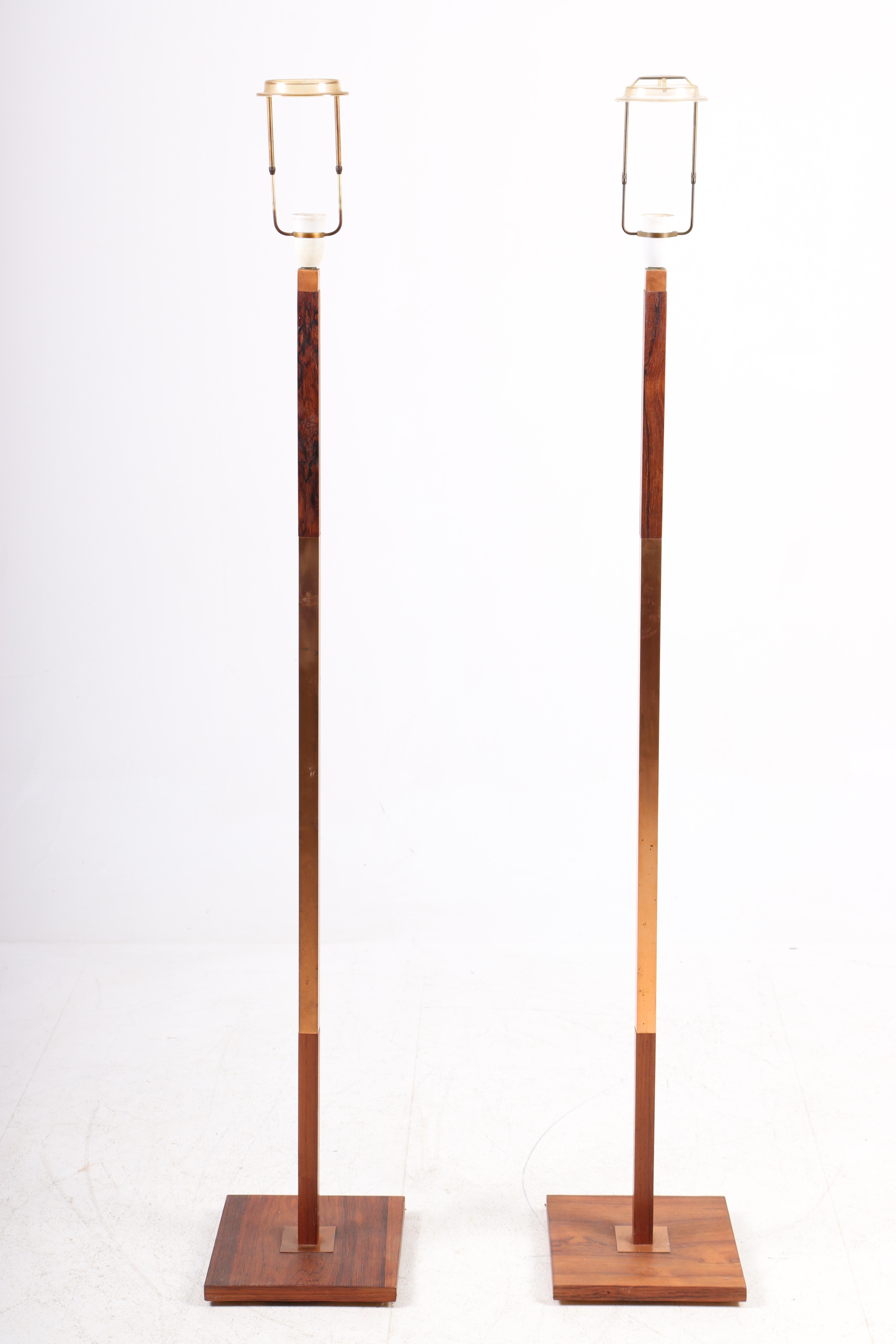 Pair of great looking floor lamps in rosewood and copper. Designed by Jo Hammerborg and made by Fog & Mørup in the mid-1950s. Great original condition.