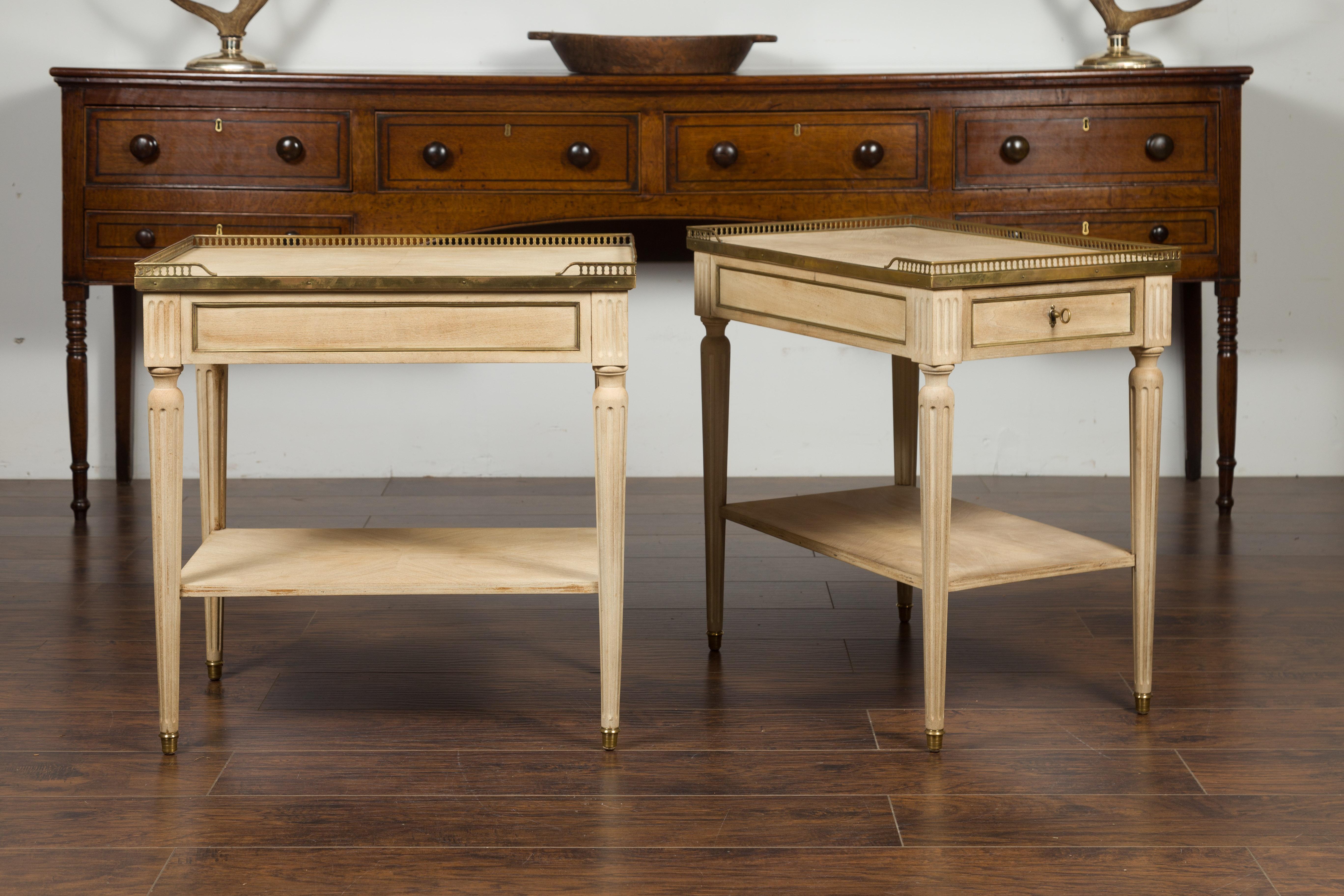 A pair of vintage French walnut bleached wood end tables from the mid-20th century, with bronze gallery, brass trim and drawers. Created in France during the midcentury period, each of this pair of end tables features a quarter-veneered rectangular
