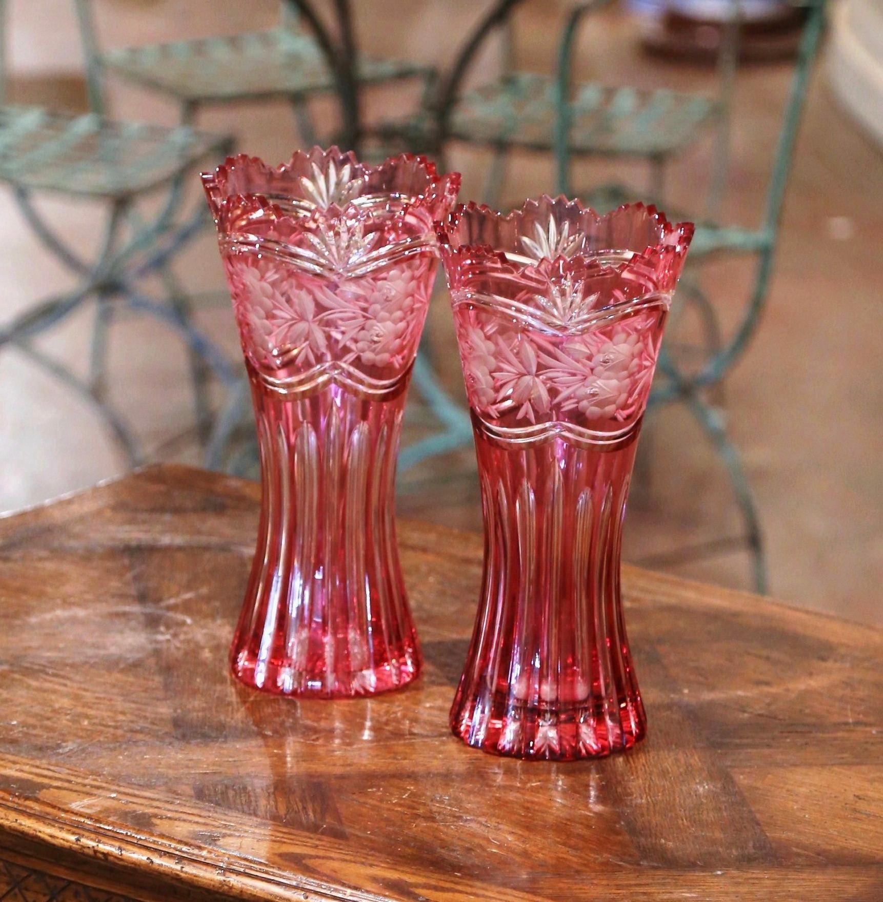 Decorate a console or buffet with this elegant pair of crystal trumpet vases in the manner of Saint Louis. Crafted in France, circa 1960 and round in shape, the large luxurious cut glass vessels are decorated throughout with frosted and etched