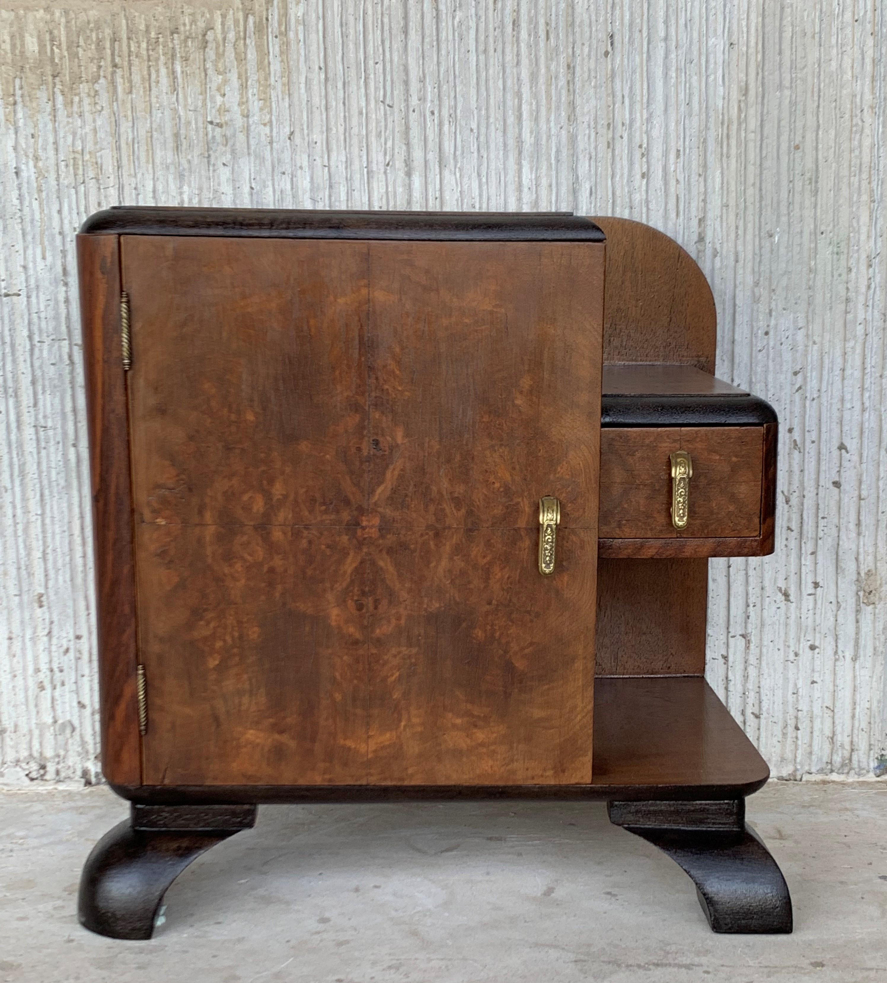 Pair of Mid-Century Modern front nightstands with original hardware and one hidden drawer and one exterior drawer like a shelve.
This beautiful pair of vintage modern nightstands feature two cabinet doors that open to unveil a large compartment for