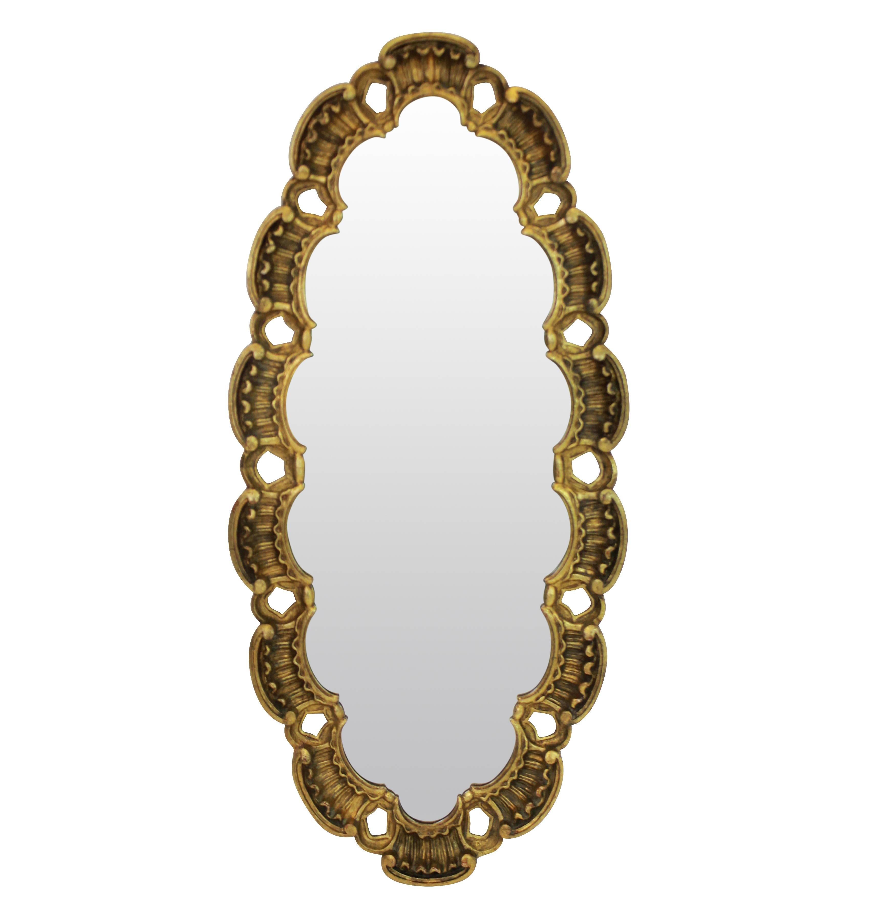 A pair of Italian midcentury carved and giltwood mirrors of oval shape.

   