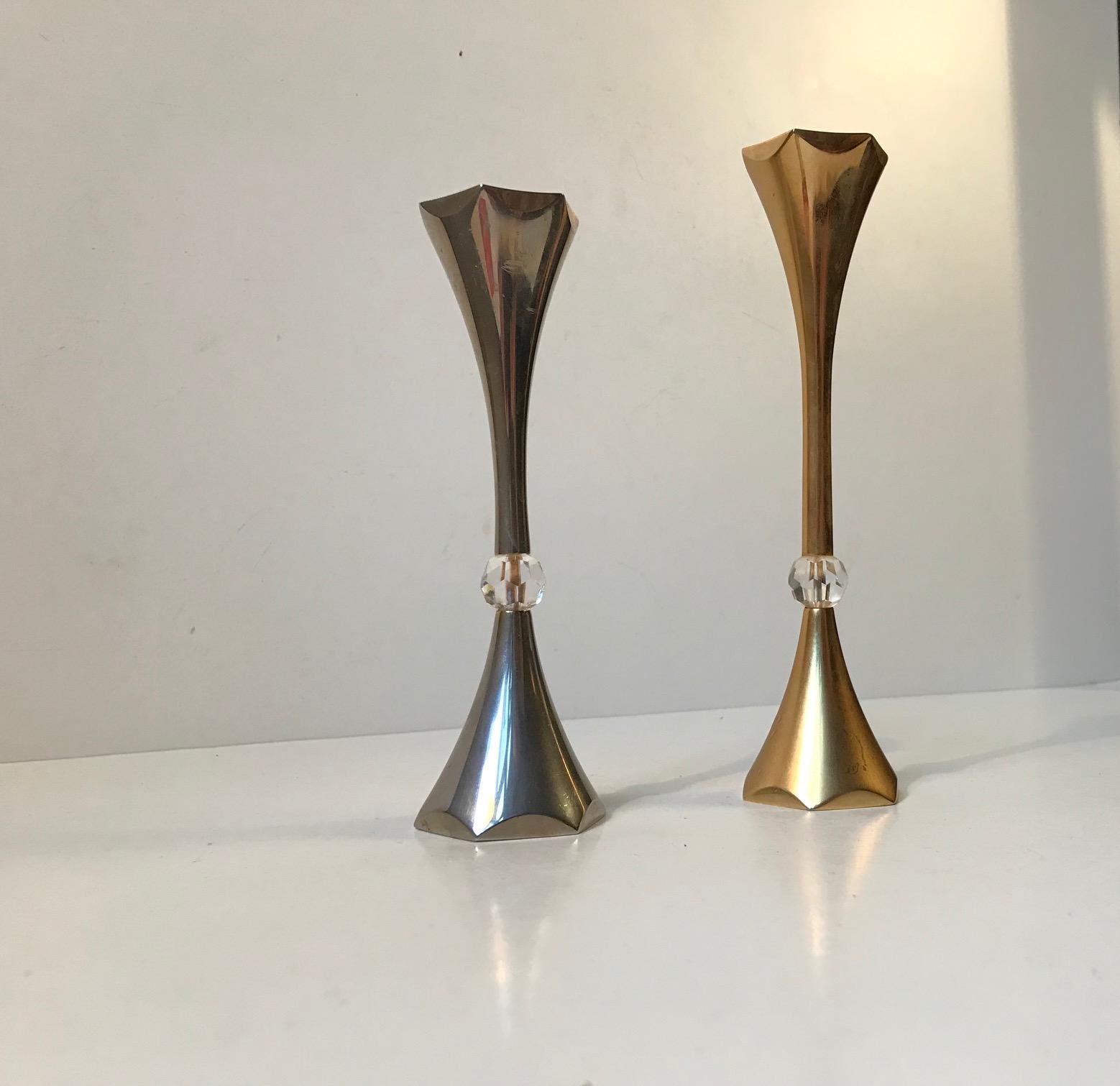 - A pair of 24-carat gold-plated candleholders with faceted crystal beads
- One is in yellow gold plating and one in white
- Designed by Hugo Asmussen
- Manufactured by the Asmussen company in Denmark during the 1960s
- They are suited for