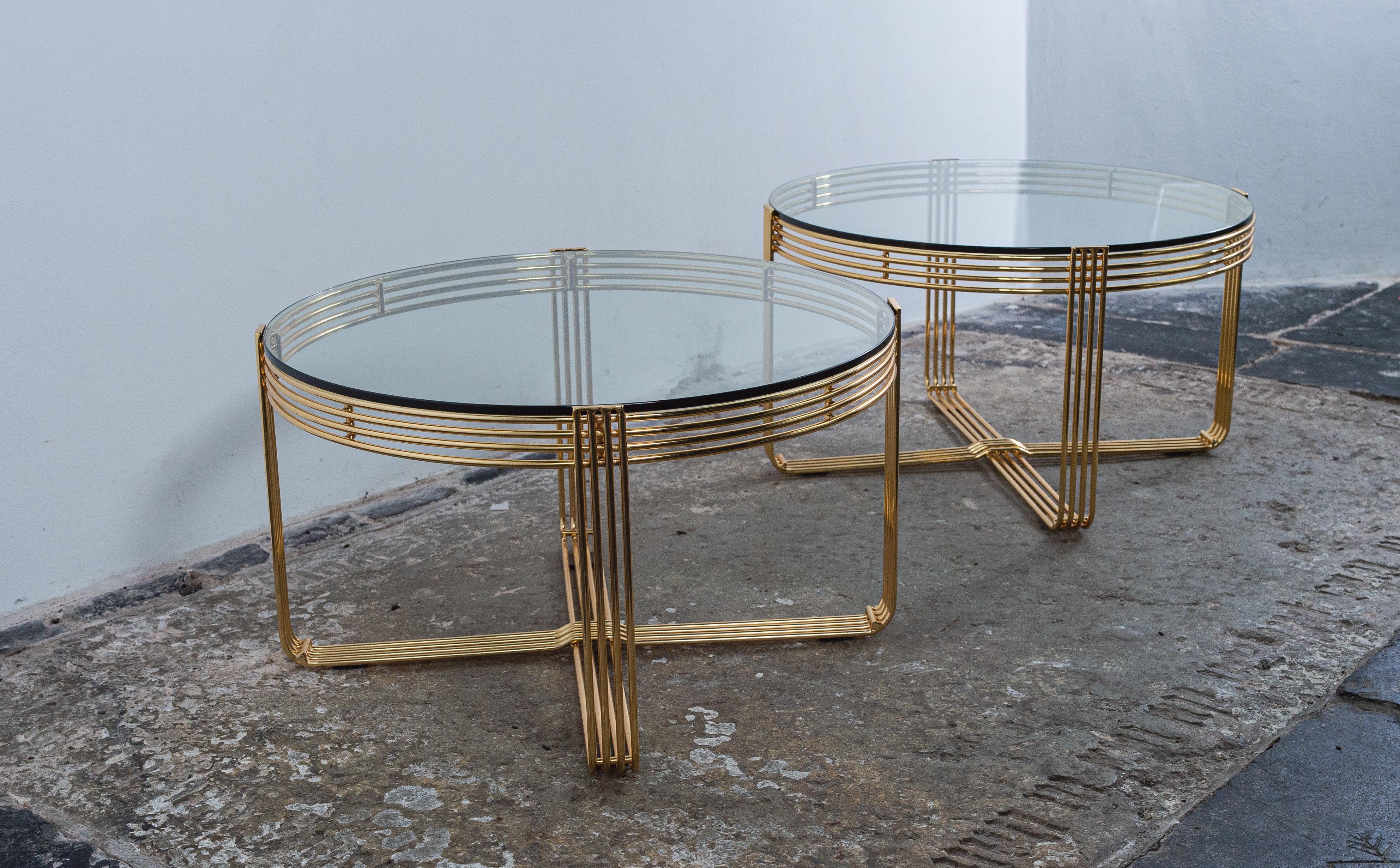 Pair of guilded steel wire tables in a stunning condition.
Very clean look that will compliment any interior.
Industrial shape but the gold color gives warmth to your space.
The glass plates are made of hardened glass.
 
