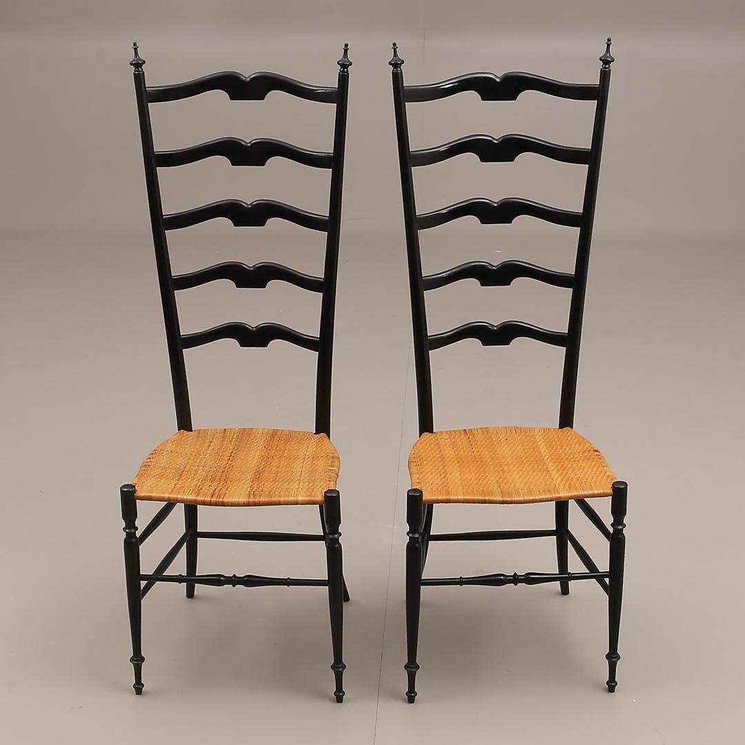 Midcentury pair of Italian chairs, produced in the 1950s in Chiavari Italien. Slim design and amazingly light. Ebonized hardwood frame with cane seat.
Normal patina due to age and use.
Set of two.