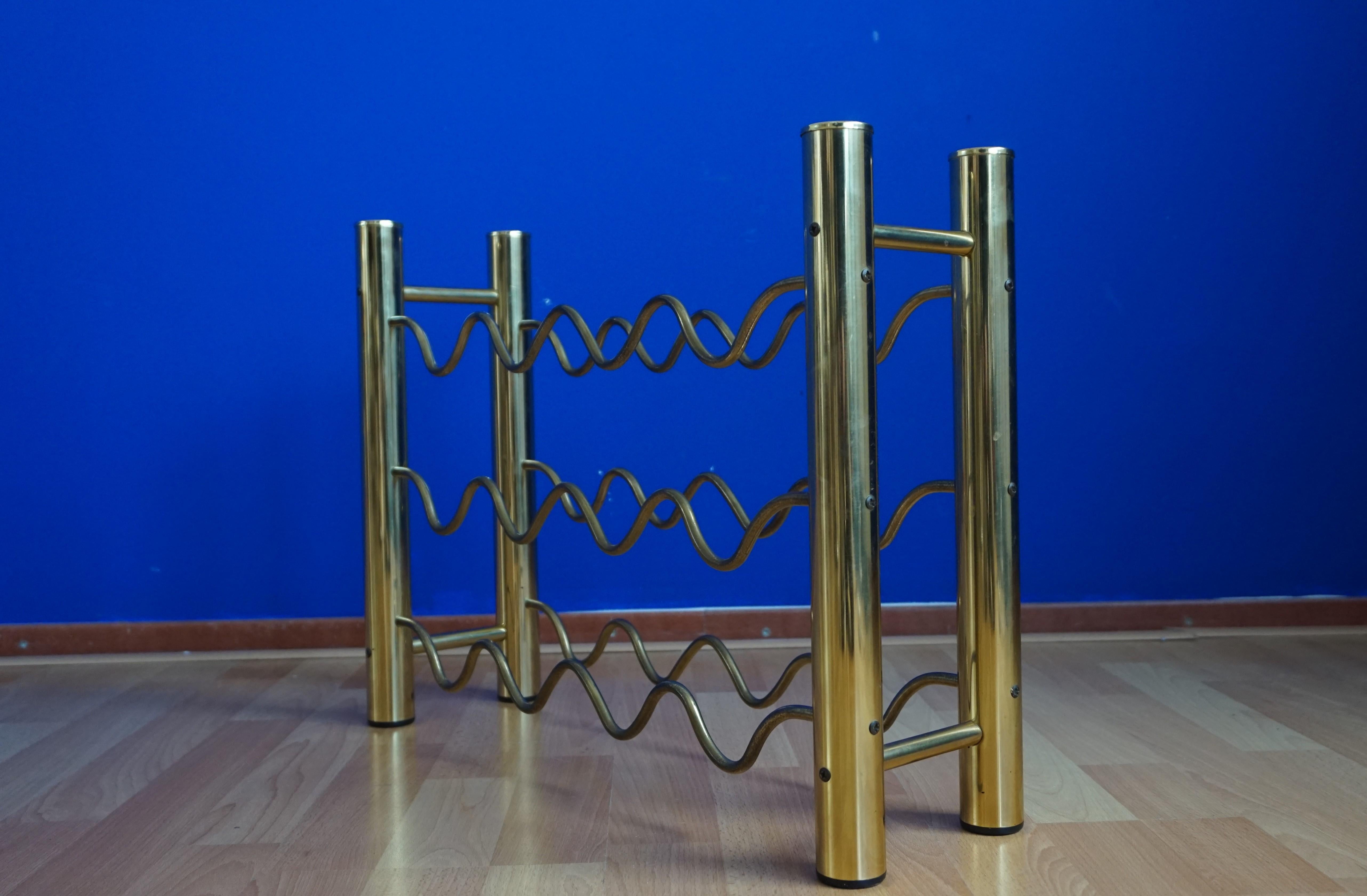 Stylish and practical pair of brass wine racks.

Finding one rare piece in the Hollywood Regency style is a beautiful thing, finding a pair makes them even more special. We were able to acquire this marvelous pair of wine racks last Saturday and