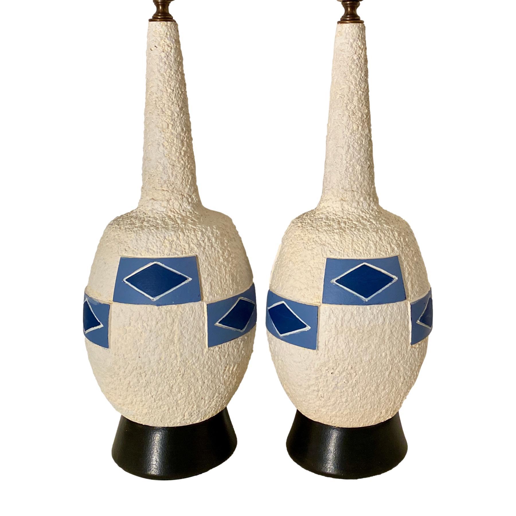 A pair of circa 1960's Italian hand printed ceramic table lamps with painted wood bases.

Measurements:
Height of body 20