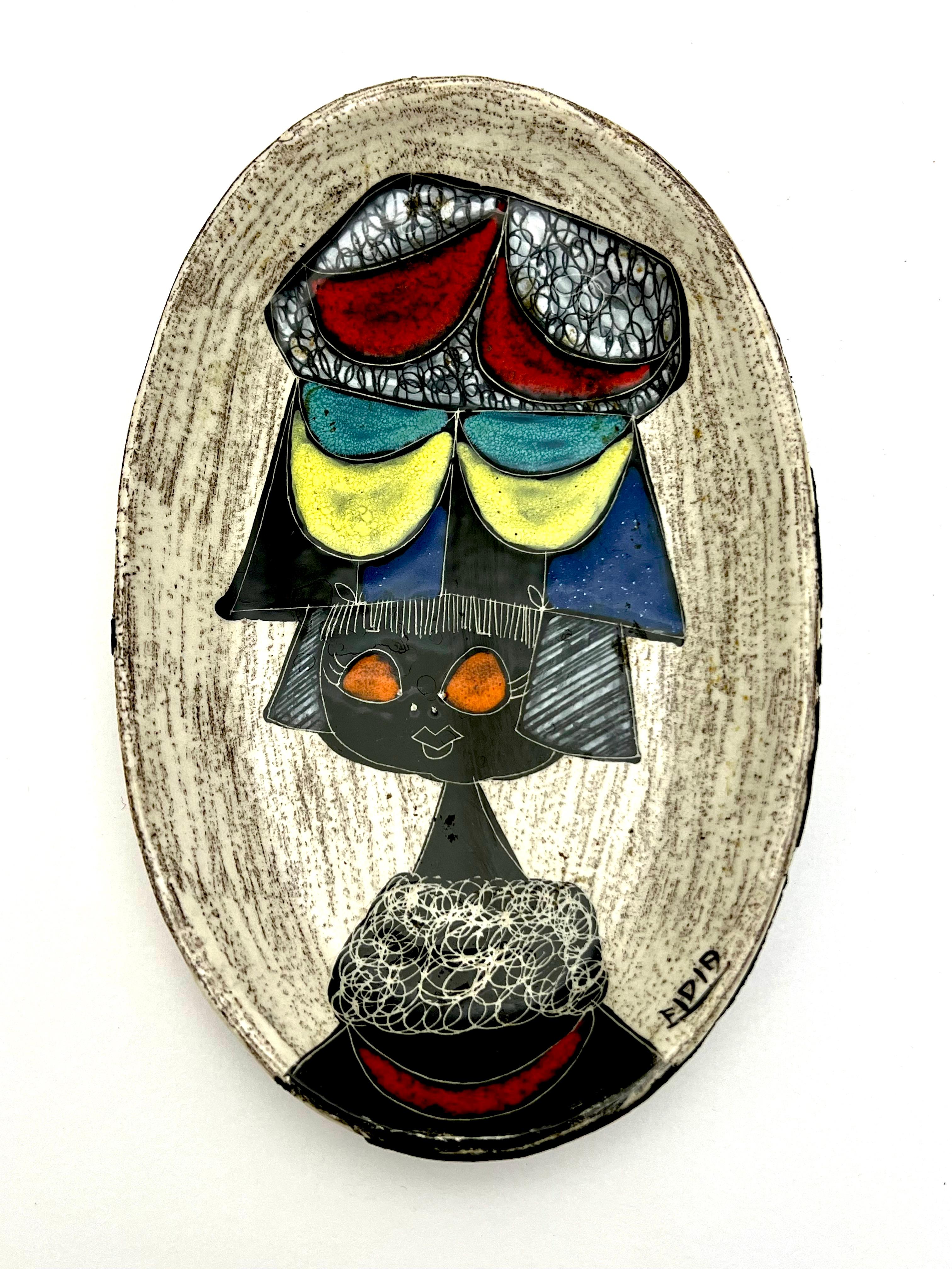 Fabulous Italian hand painted figural bowl and tray by Fidia. These big eyed girls are in the style of Fantoni. Bound in leather on the back these are great midcentury accents that the Italian masters like Fornasetti and Fantoni mastered so