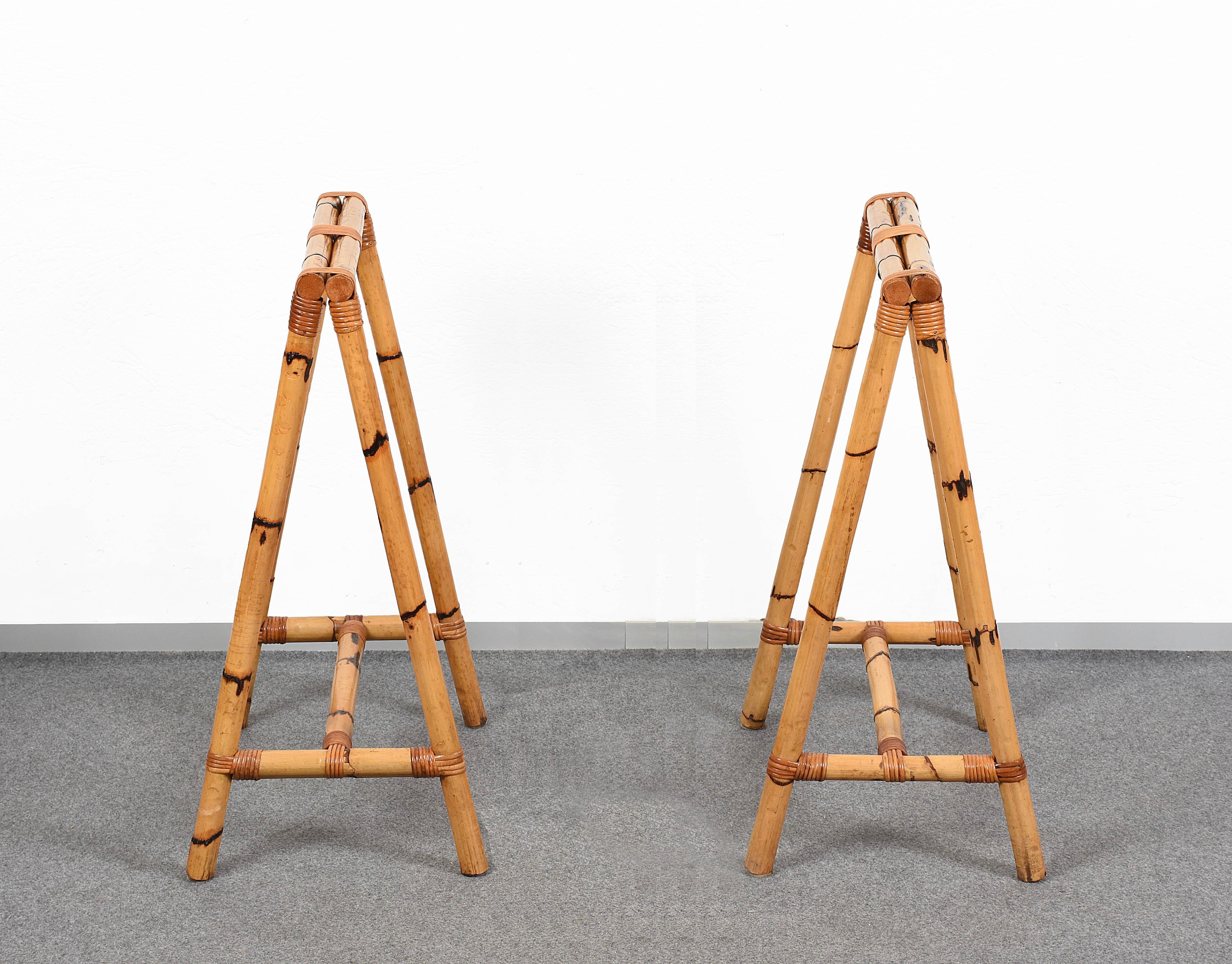 Pair of midcentury four-legs easels in bamboo and rattan.

This set of two pieces was produced in Italy during the 1970s.

These items are very versatile and will be perfect for creating a table or a desk because of their bamboo structure with