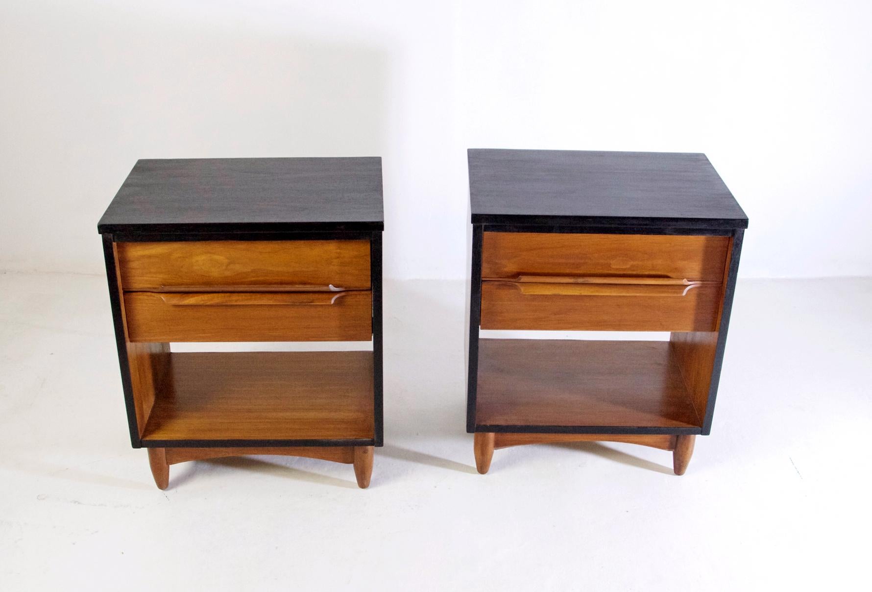 A pair of handmade nightstands in teak from the 1950's with an ebonized frame.  Each nightstand has a pair of drawers and are in excellent restored condition. There is also a matching dresser for this pair.