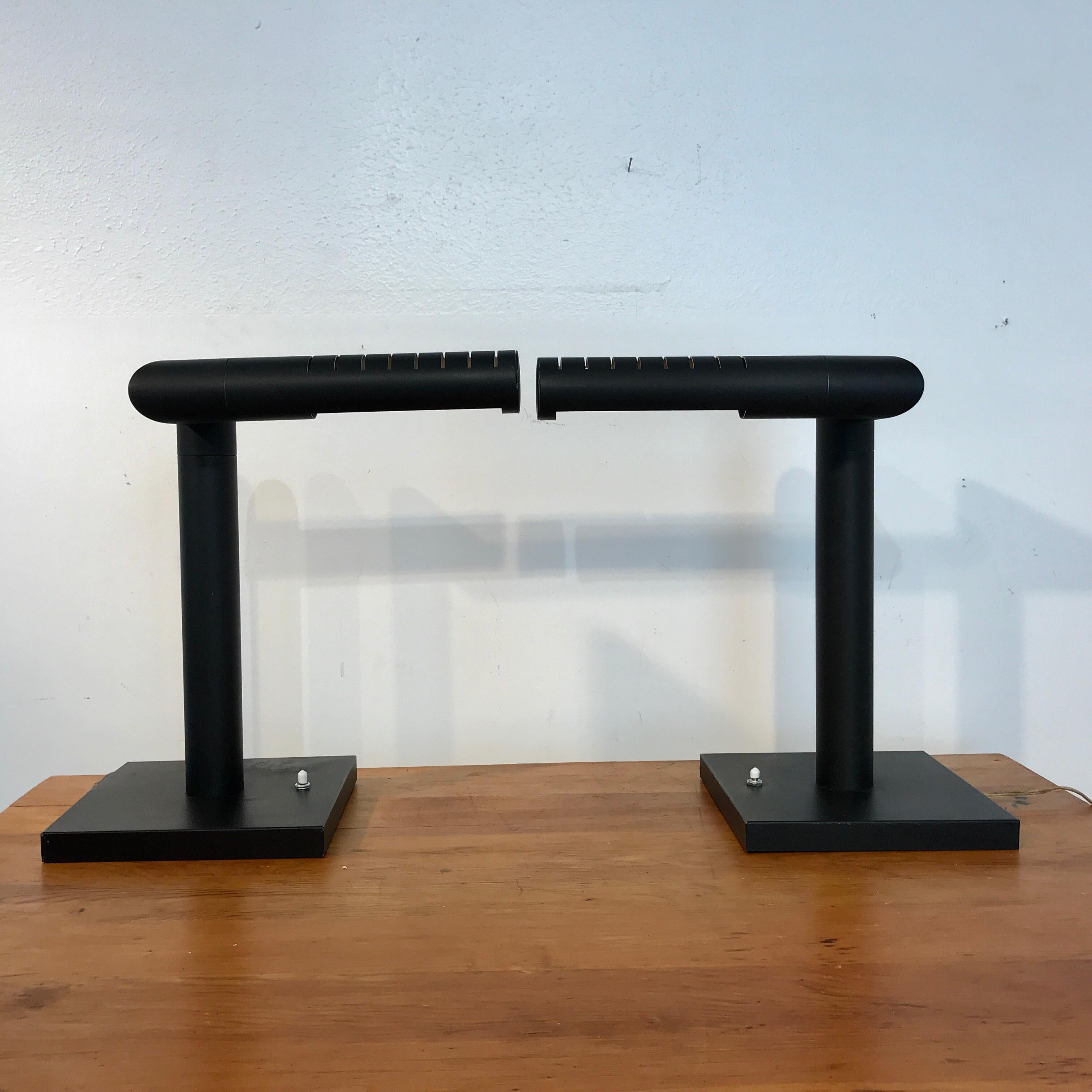 Pair of midcentury Italian Periscope desk lamps, each one blackened tubular form with numerous positional options. Each one raised on a 9