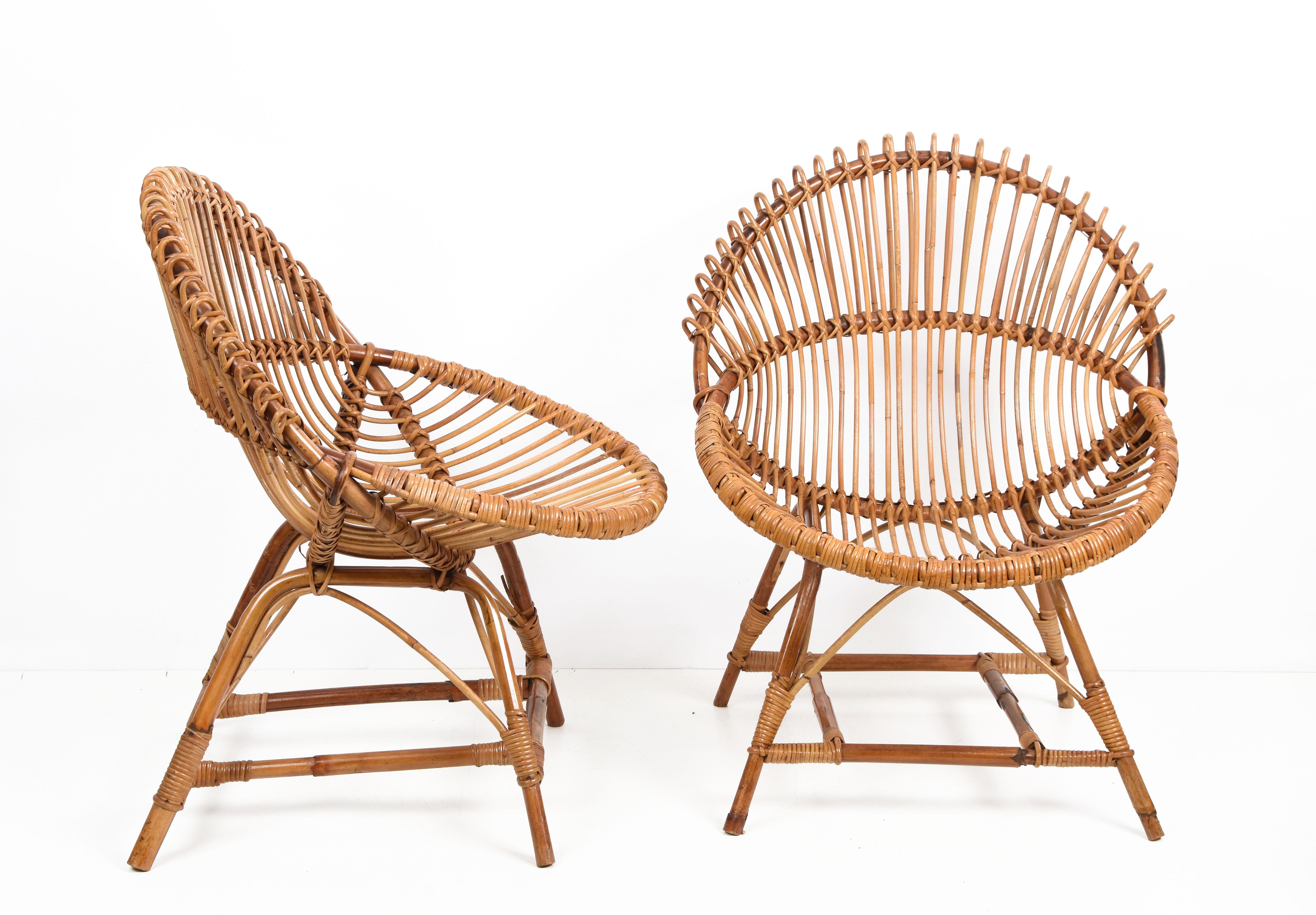 Amazing pair of midcentury rattan shell-shaped armchairs. These pieces were produced in Italy during 1950s and are attributed to Franco Albini.

The uniqueness of this set is due to the solid, shell shape of the rattan seat. A sensational mix that