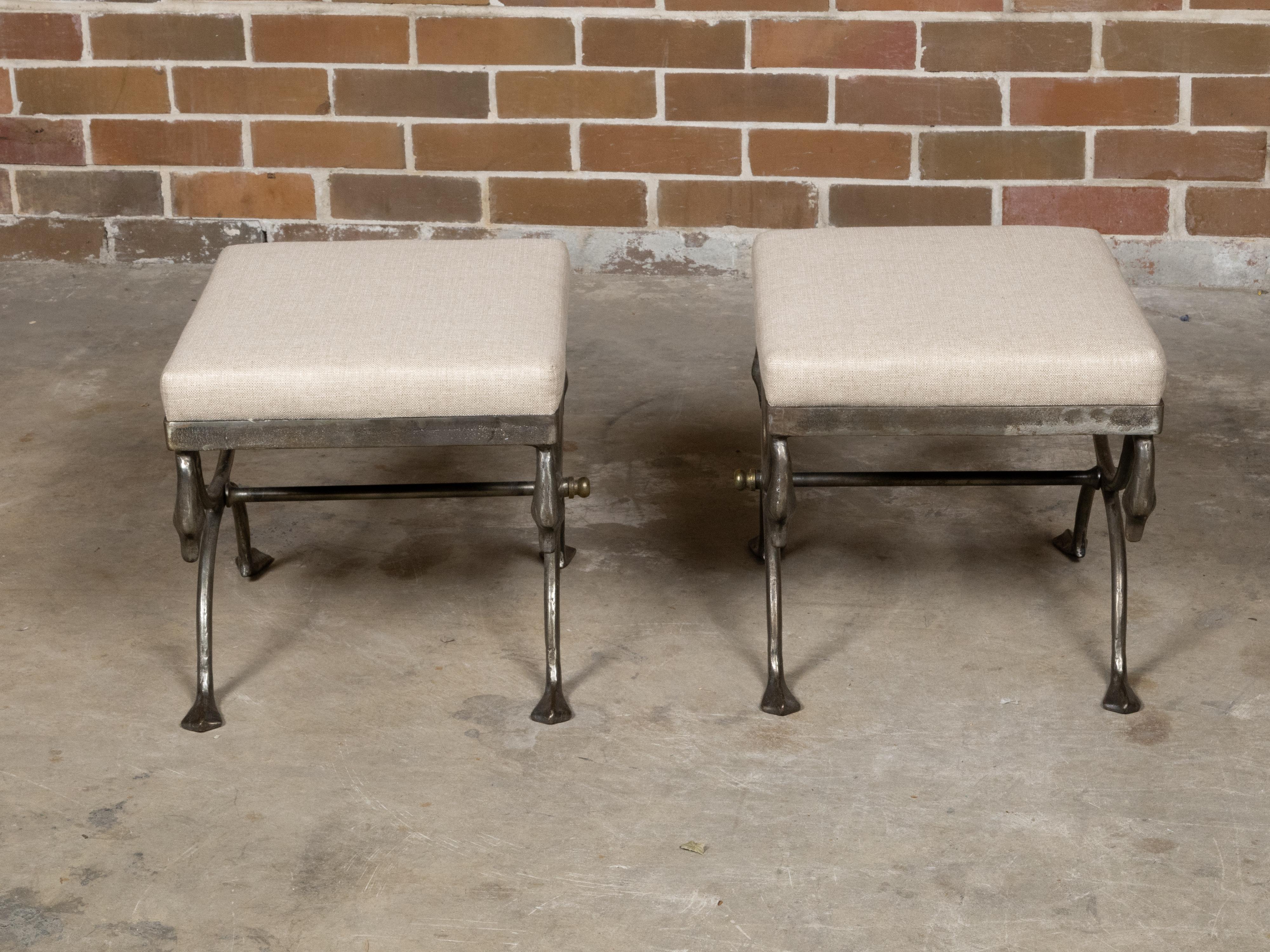 A pair of Italian steel stools from the Midcentury period with swan neck motifs, pad feet and neutral toned custom linen upholstery. This stunning pair of midcentury Italian steel stools exudes sophistication with their elegant swan neck motifs and