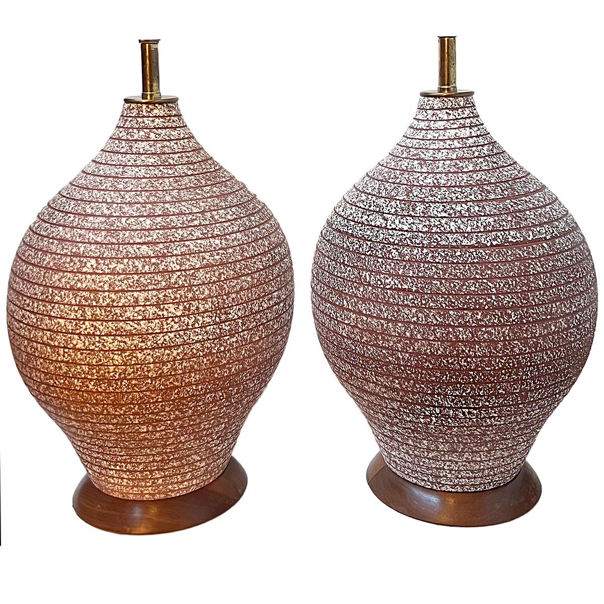 Pair of circa 1960's Italian pottery lamps with wooden bases.

Measurements:
Height of body: 17