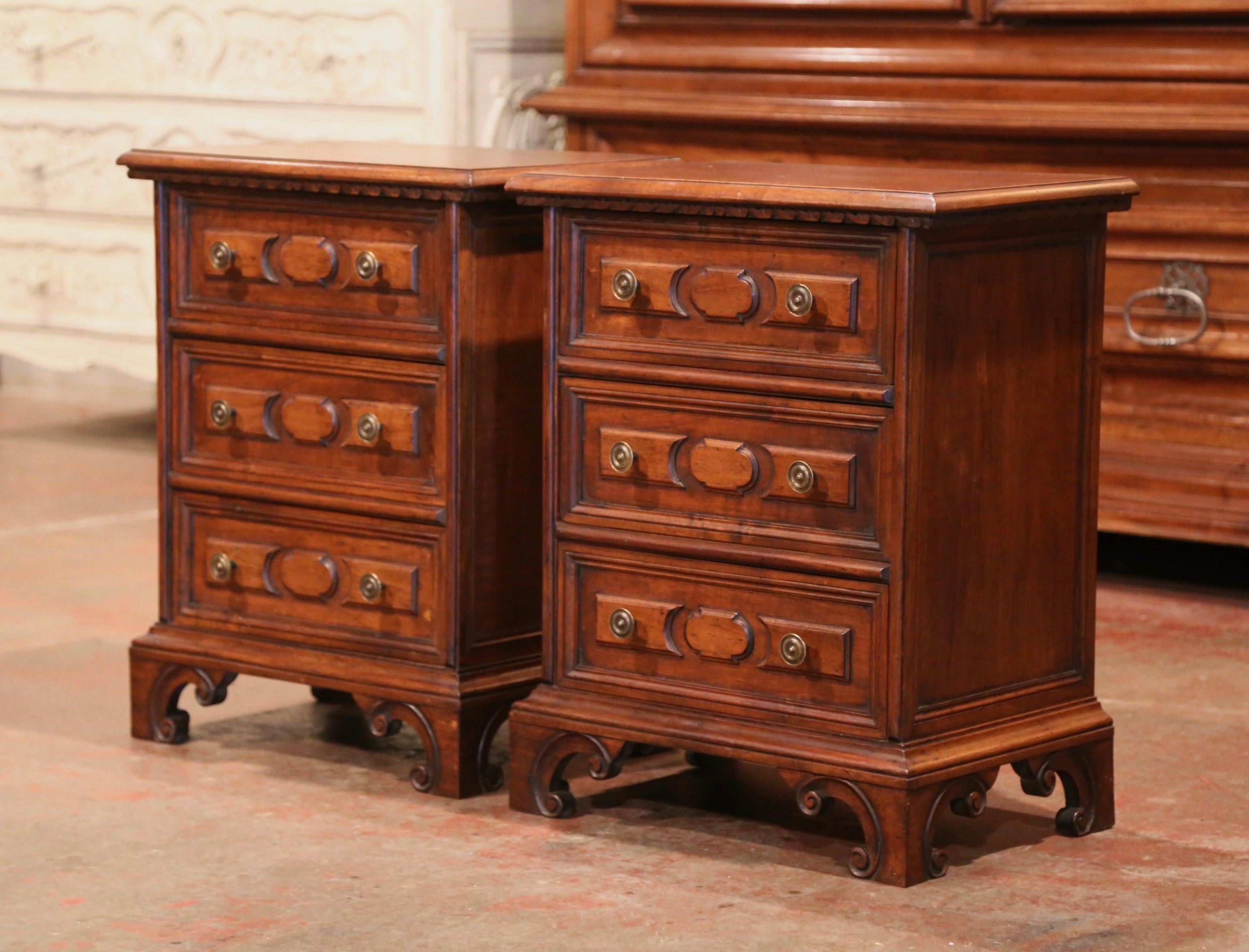 Decorate a master bedroom with this elegant pair of nightstands; crafted in Italy circa 1950, each chest stands on bracket feet and features three paneled drawers decorated with brass pulls. The vintage bedside tables are in excellent condition with