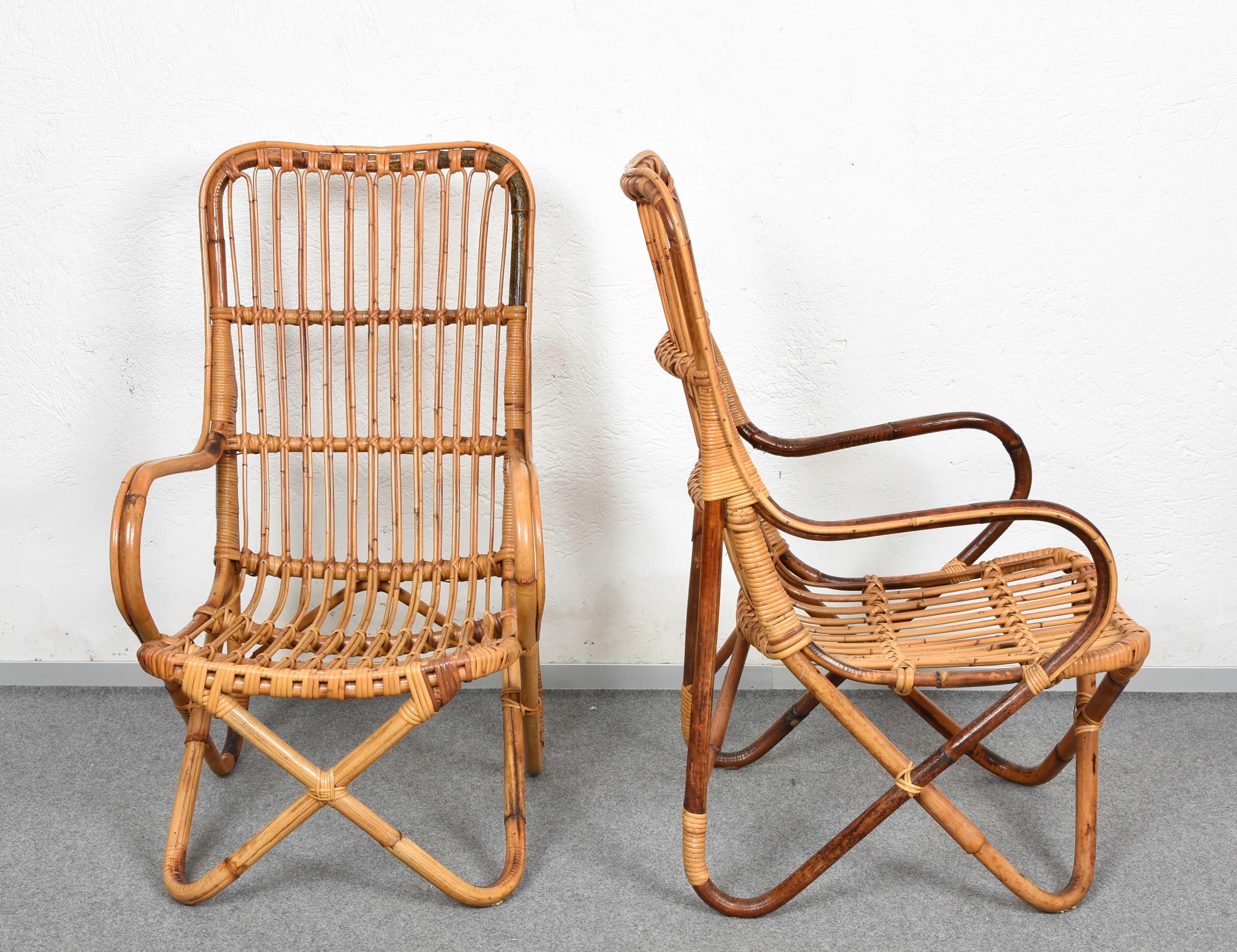 Incredible pair of Mid-Century Modern rattan and bamboo armchairs. This fantastic set was produced in Italy during the 1960s in the style of Tito Agnoli.

The seat is assembled with thin rattan elements while the structural elements are in bamboo,