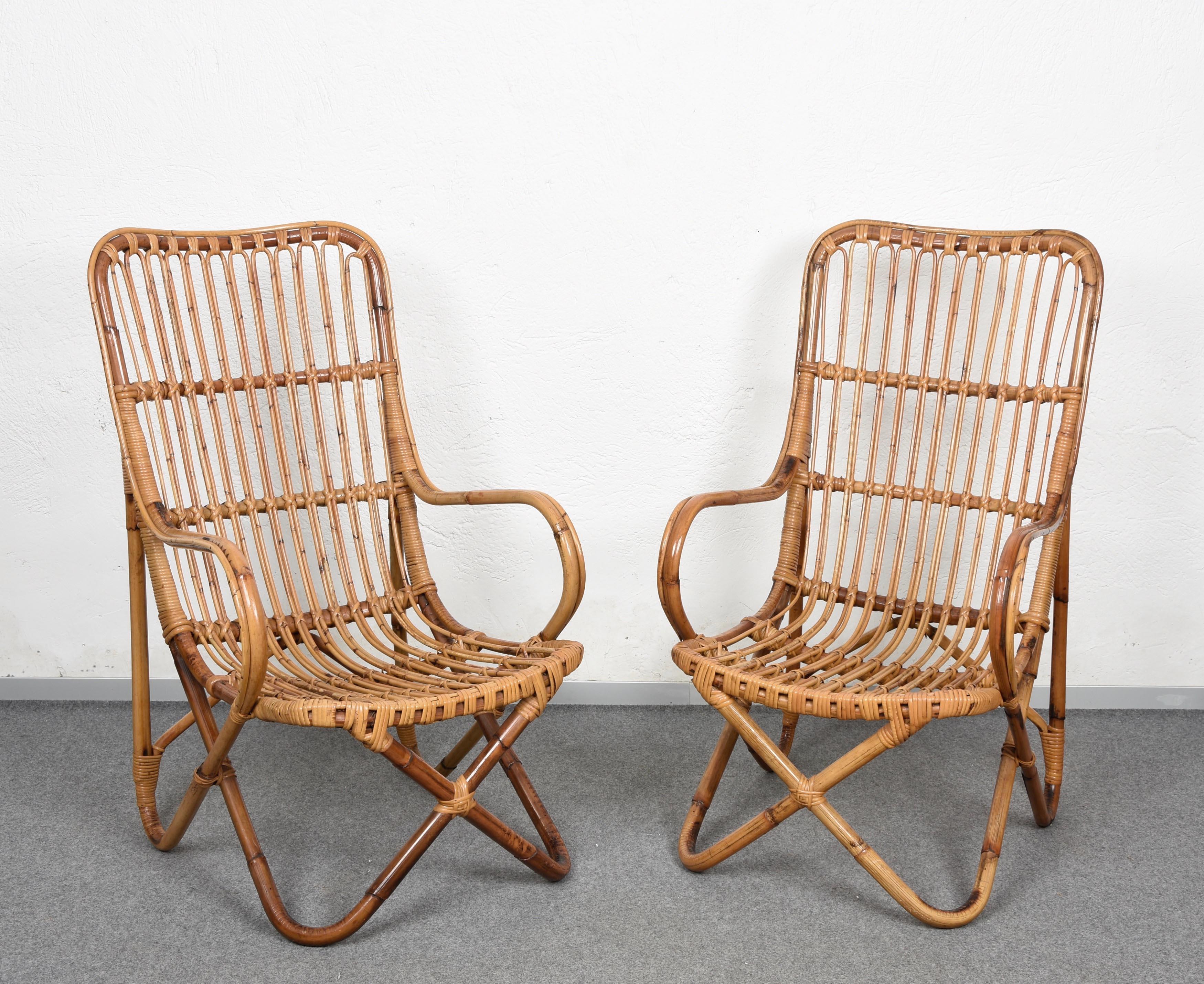 Incredible pair of Mid-Century Modern rattan and bamboo armchairs. This fantastic set was made in Italy during the 1960s in the style of Tito Agnoli.

The seat is made of thin rattan elements while the structural elements are in bamboo, which