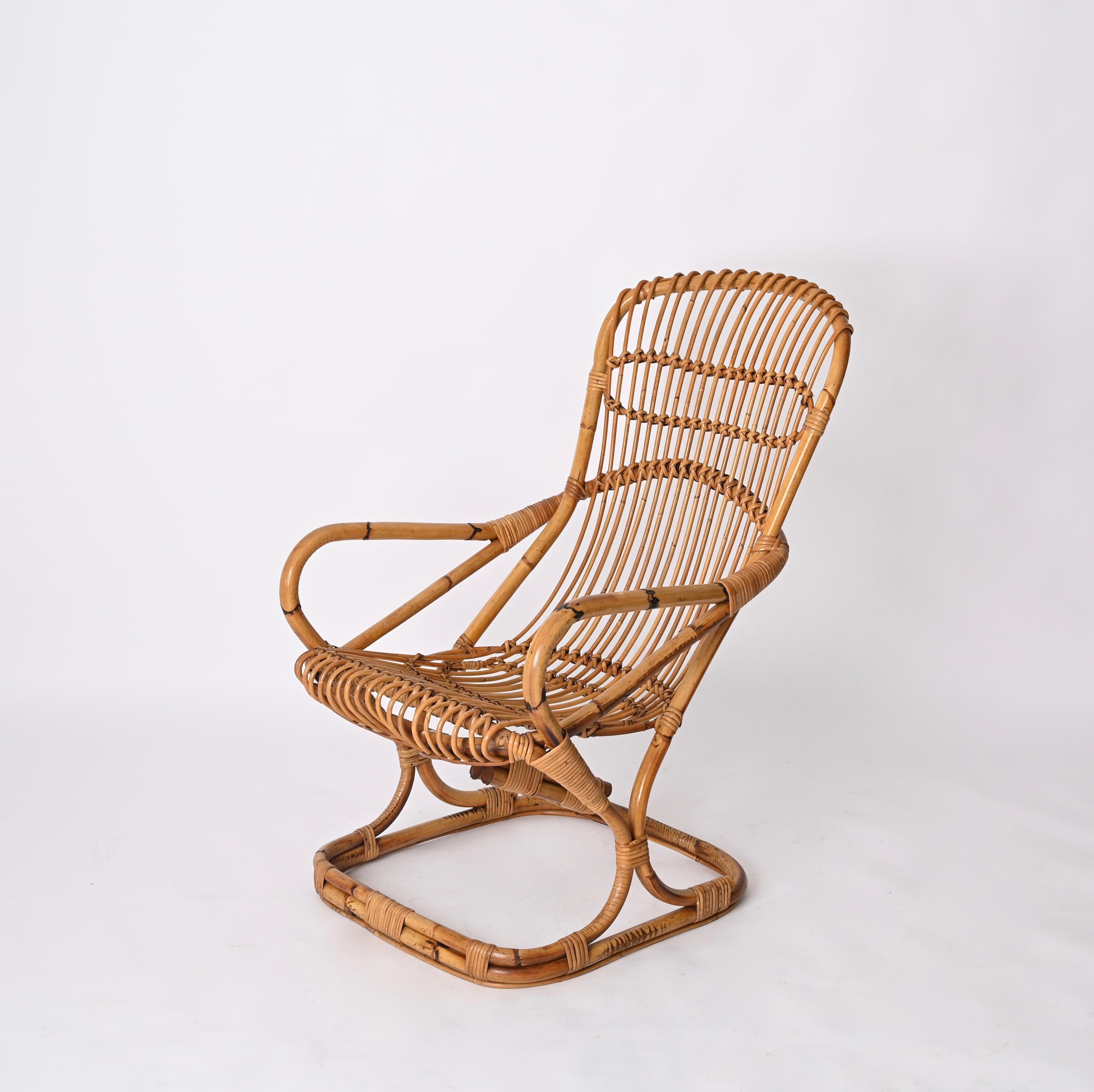 Incredible pair of Mid-Century Modern armchairs fully made in bamboo, curved rattan and hand-woven wicker. These majestic armchairs were designed by Tito Agnoli and produced in Italy dutinh the 1960s.

The armchairs are in excelent conditions. Fully