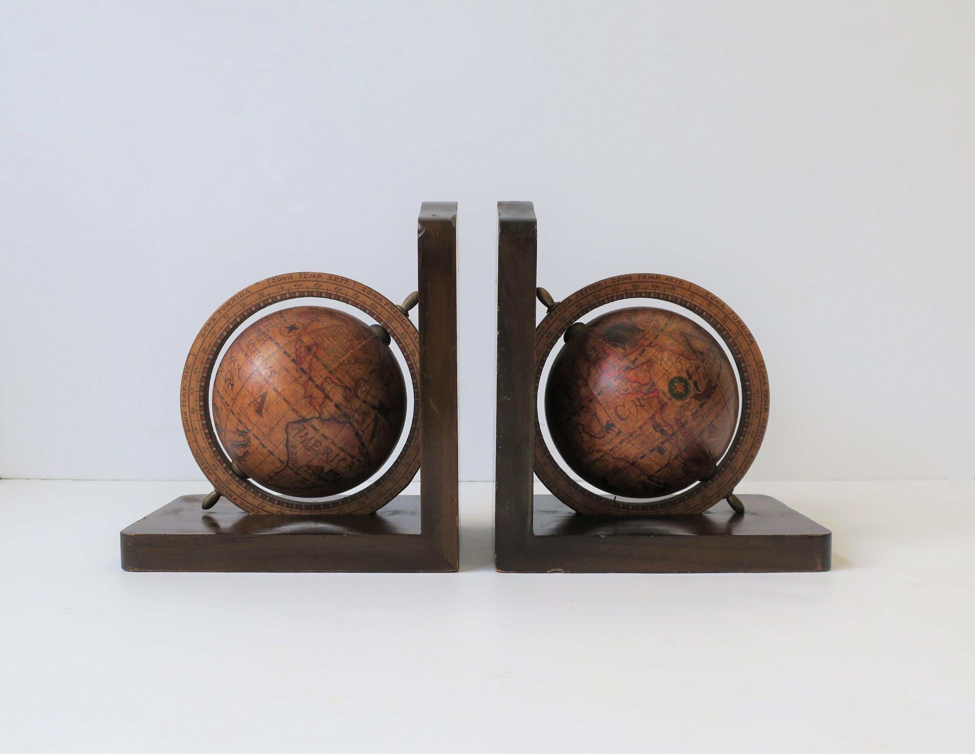 A mid-20th century pair of Italian world globe bookends with brass accents. Marked 