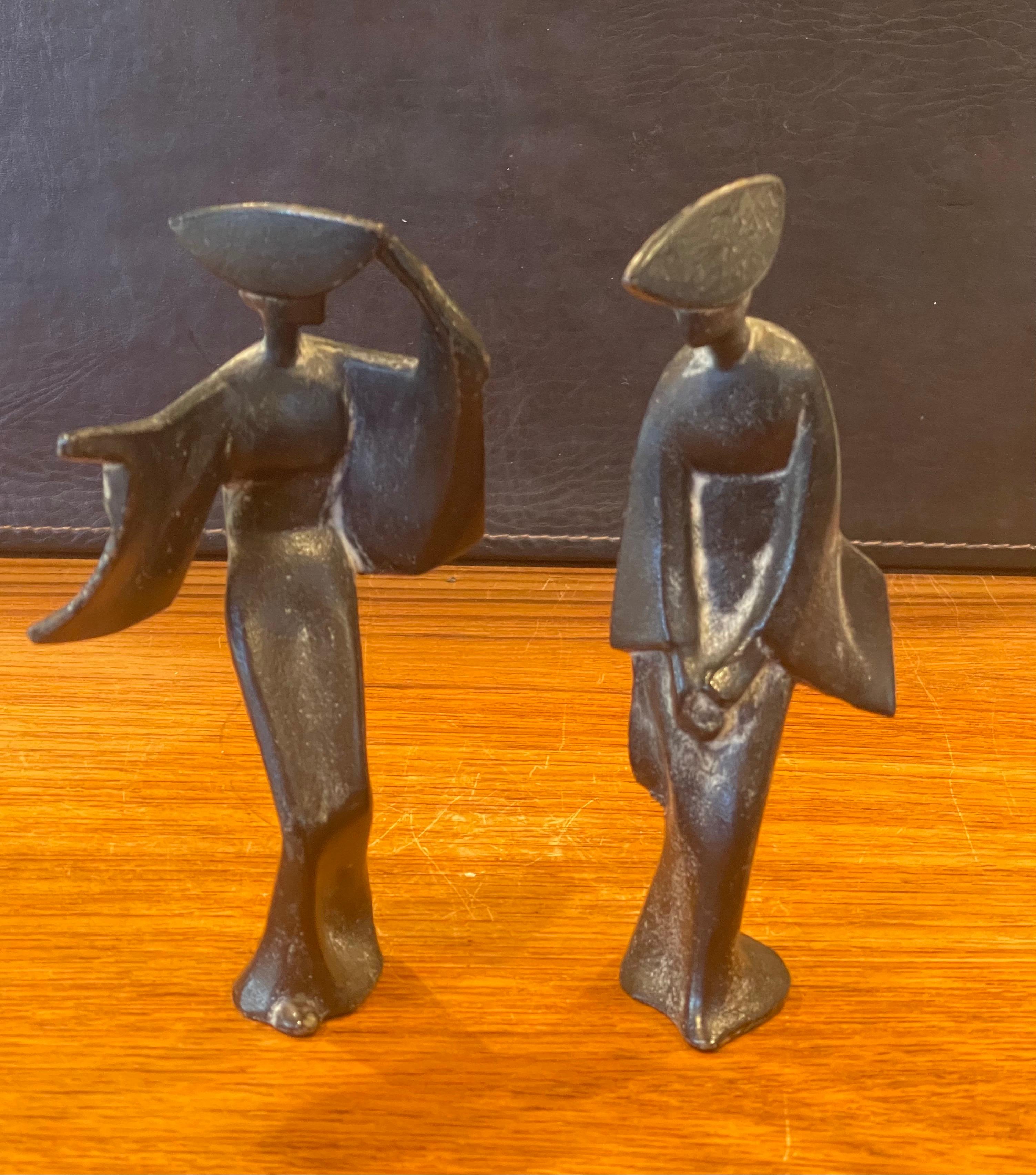 A very cool pair of Japanese geisha figurines, circa 1960s. The pieces are cast iron with verde gris finish and are quite heavy; they would make a great Mid-Century Modern accent in any space! #2119.