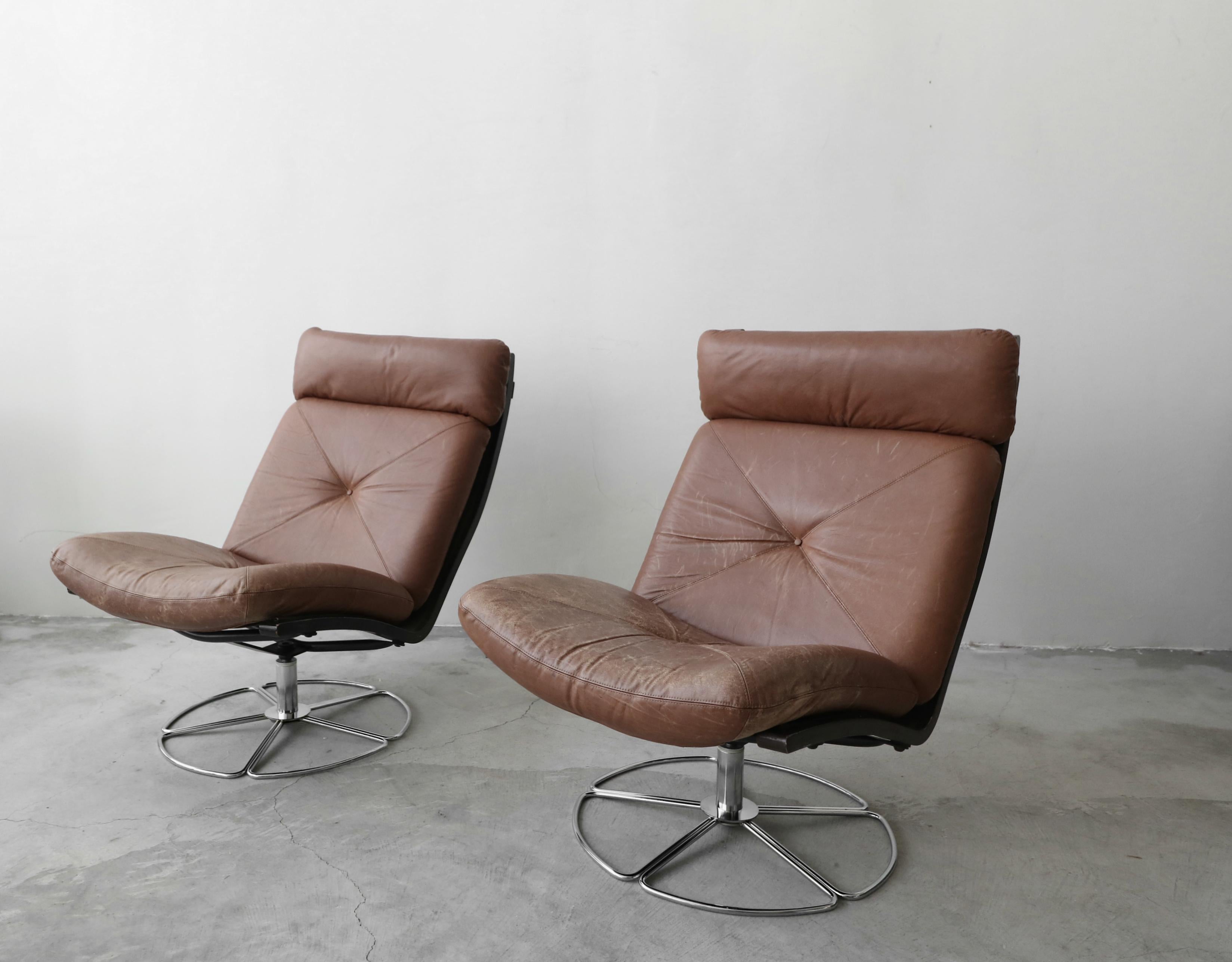 A simple yet sophisticated pair of 1970s vintage leather swivel chairs. Chairs have beautiful patina on the leather giving them lots of that age appropriate character. The chairs are in great condition for their age. Leather is worn but not damaged