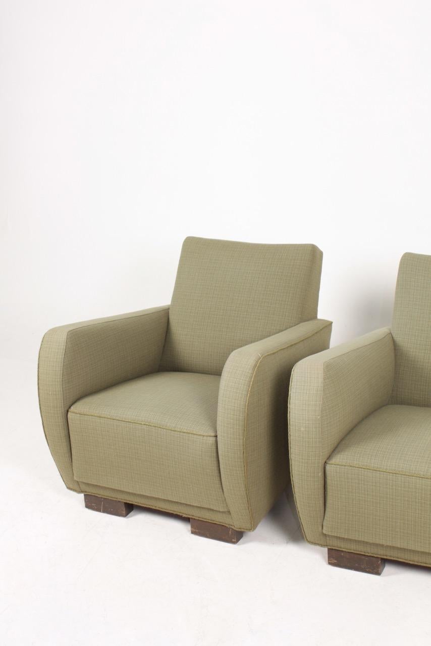 Pair of lounge chairs upholstered in fabric. Designed and made in Denmark.