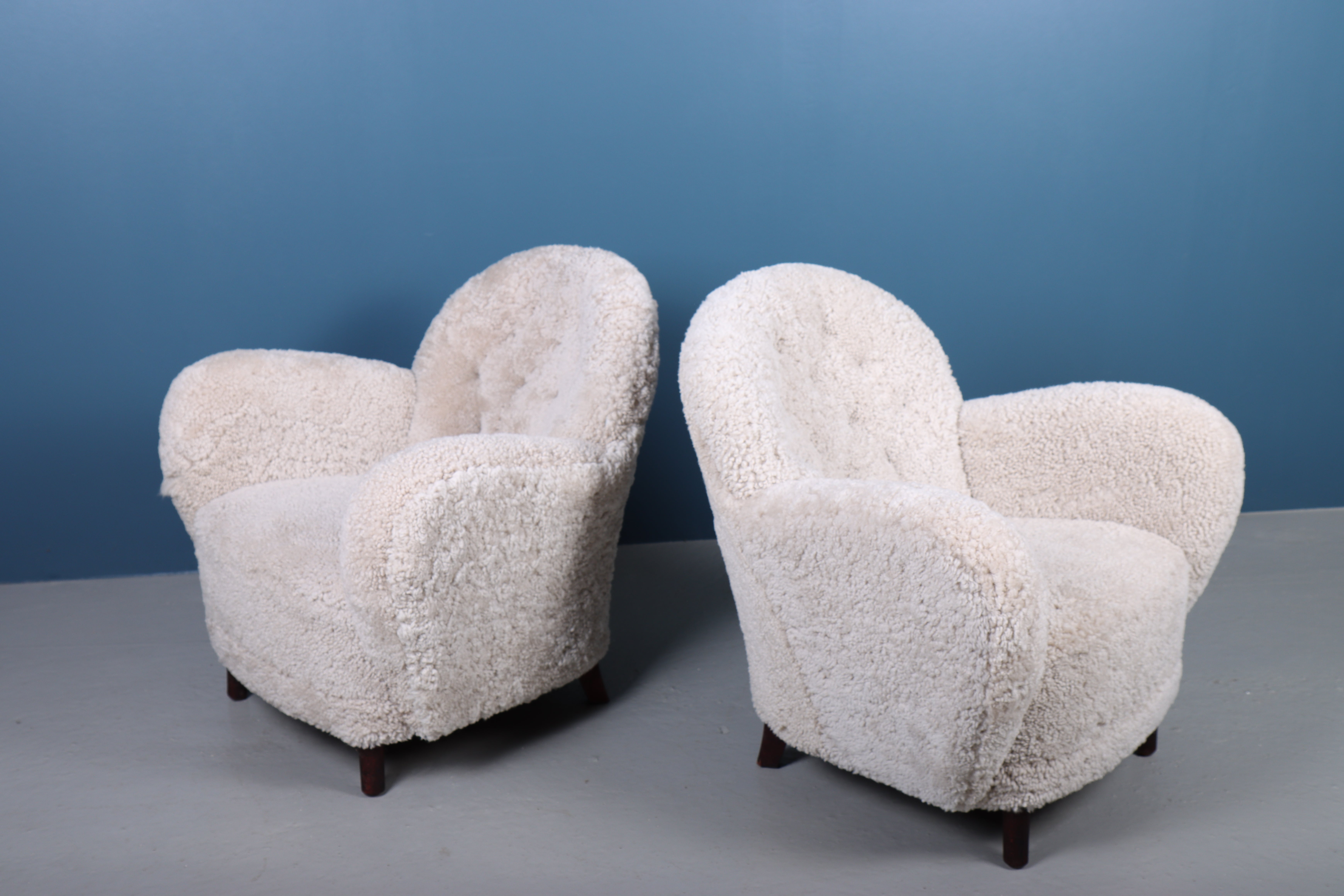 Pair of lounge chairs upholstered with sheepskin. Designed and made by Georg Kofoed, made in Denmark.