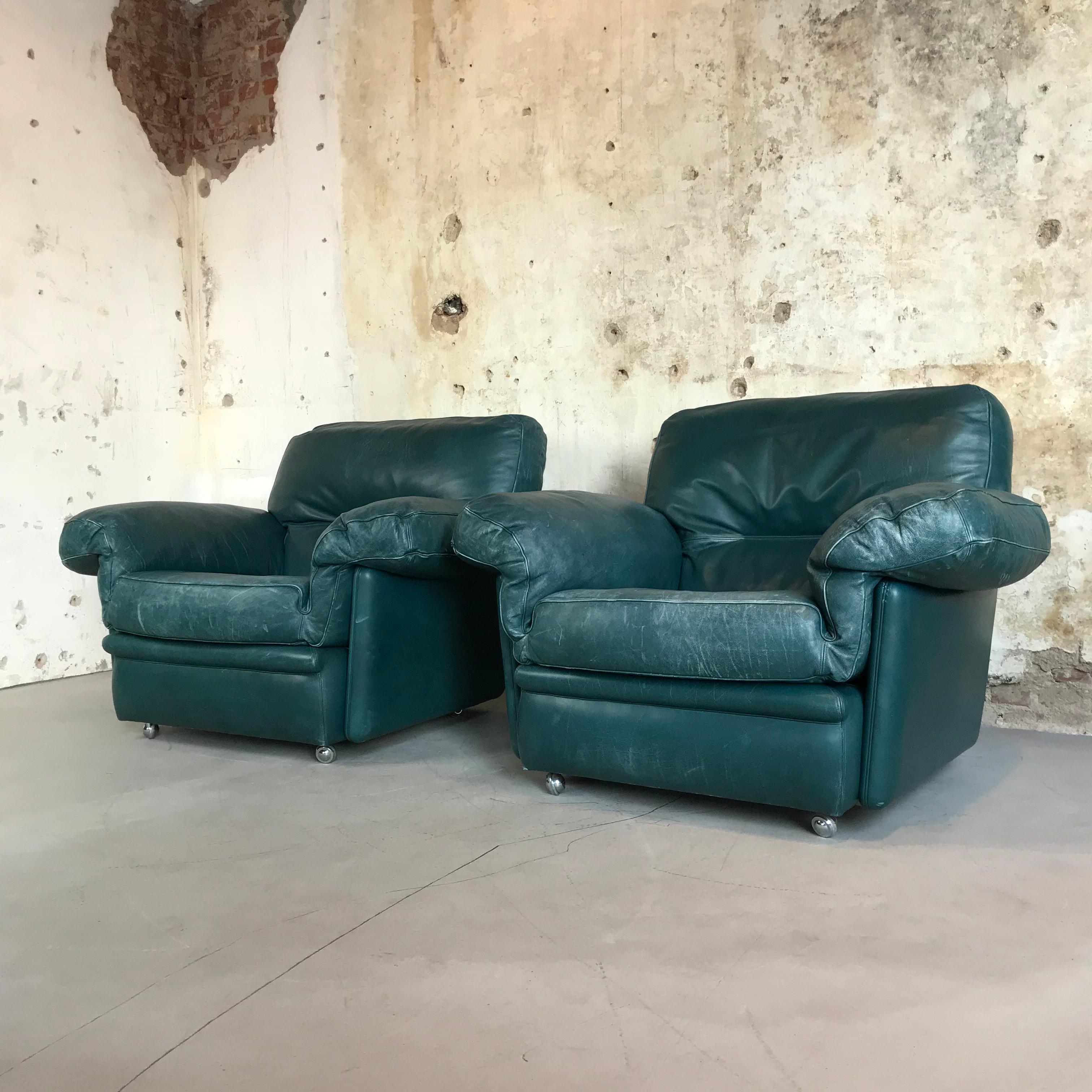 Pair of large impressive vintage lounge chairs by Poltrona Frau, 1970s, the very best quality from Italy. Comfortable overstuffed proportions in amazing luxurious petrol (bluish green) nappa leather makes these easy chairs the perfect set for home