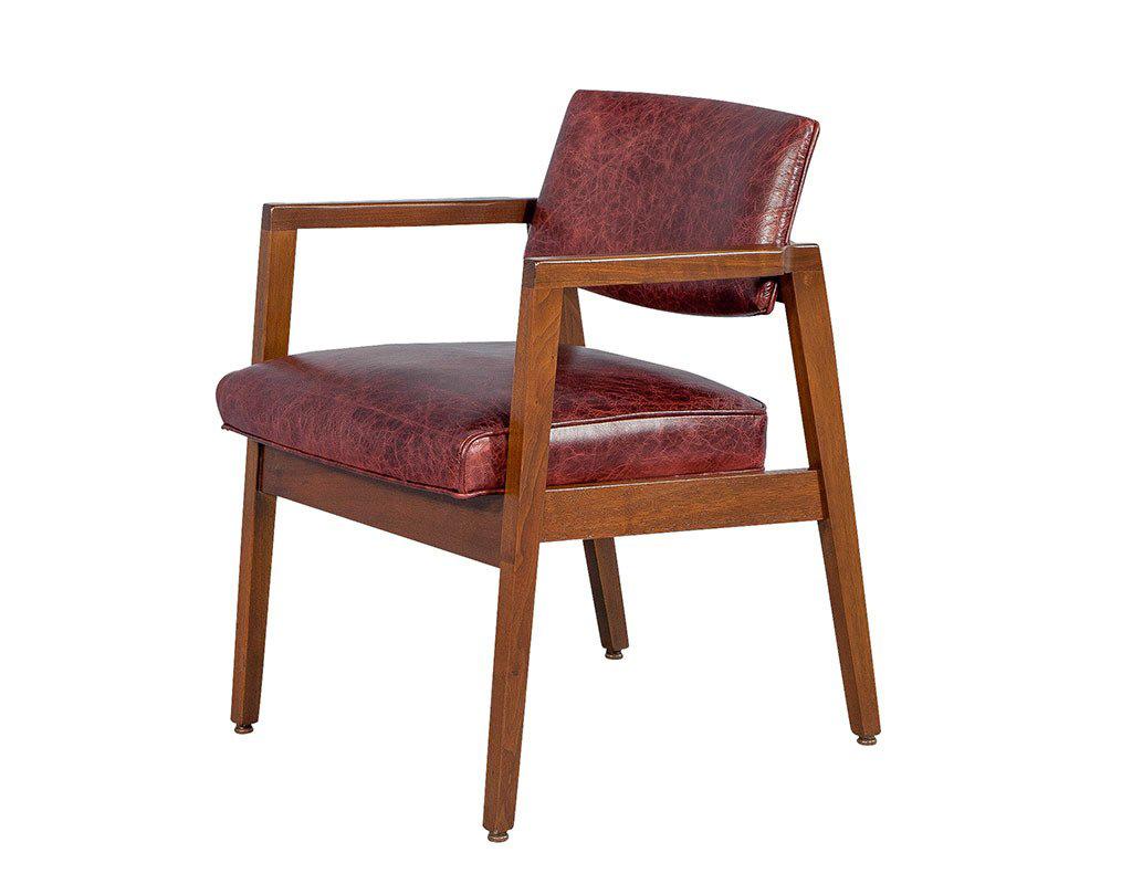 Simple but stylish, this set of two lounge chairs comes with original Mid Century Modern walnut frames in excellent condition. Cleanly joined, well finished, with gently tapered arms and a slightly bowed back, all in a soft matte finish. The frames