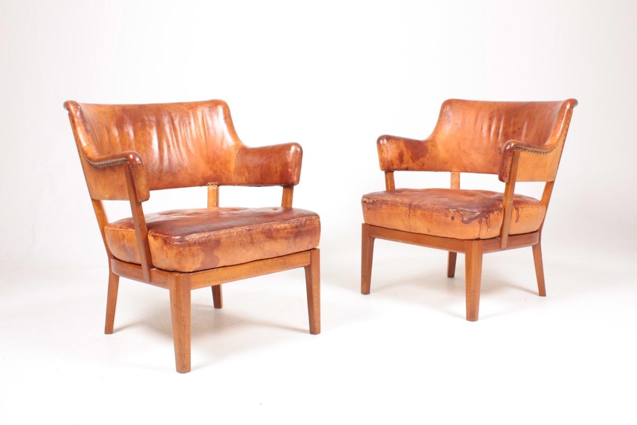 Pair of lounge chairs in patinated leather, designed and made by a Danish cabinetmaker. Original condition.