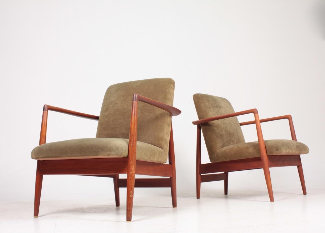 Pair of lounge chairs in oil finished teak and velvet. Designed and made by cabinetmaker C.B. Hansen. Great condition.