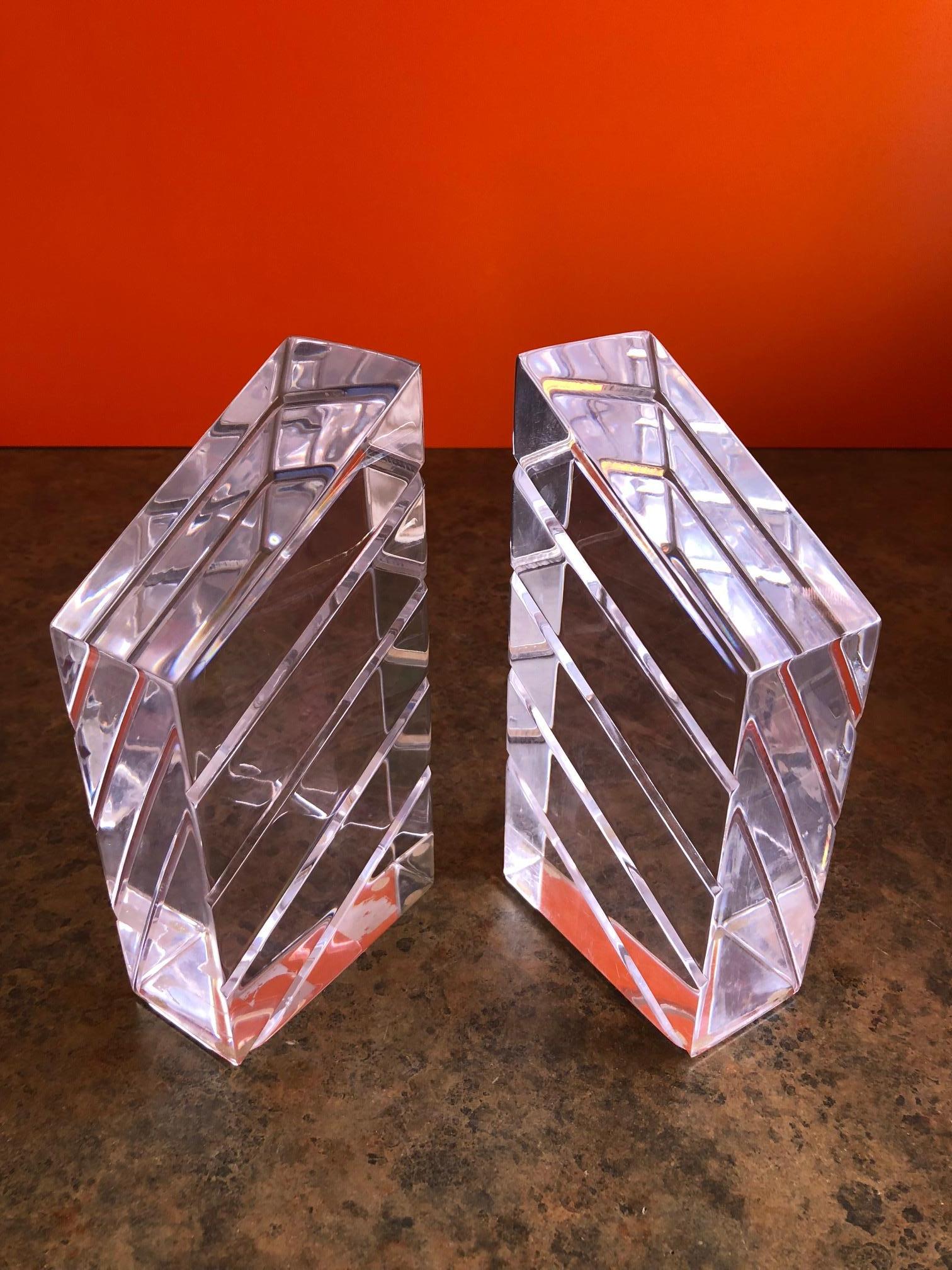 A gorgeous air of midcentury Lucite bookends by Astrolite, circa 1960s. The pair are in excellent condition and would make a great addition to any midcentury study or library!