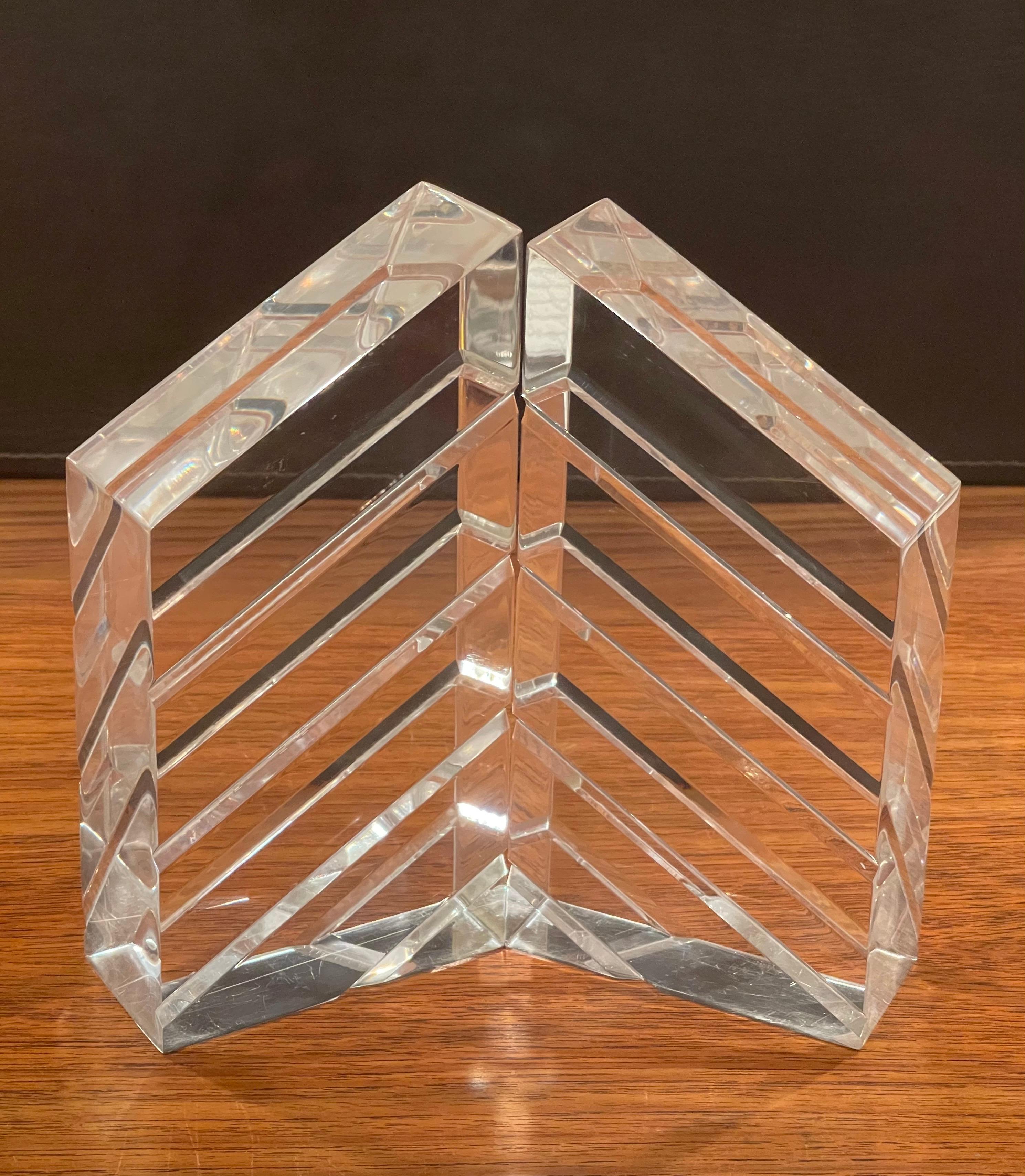 A gorgeous pair of mid-century lucite bookends by Herb Ritts for Astrolite, circa 1970s. The pair are in excellent condition and would make a great addition to any midcentury study or library! #1929.