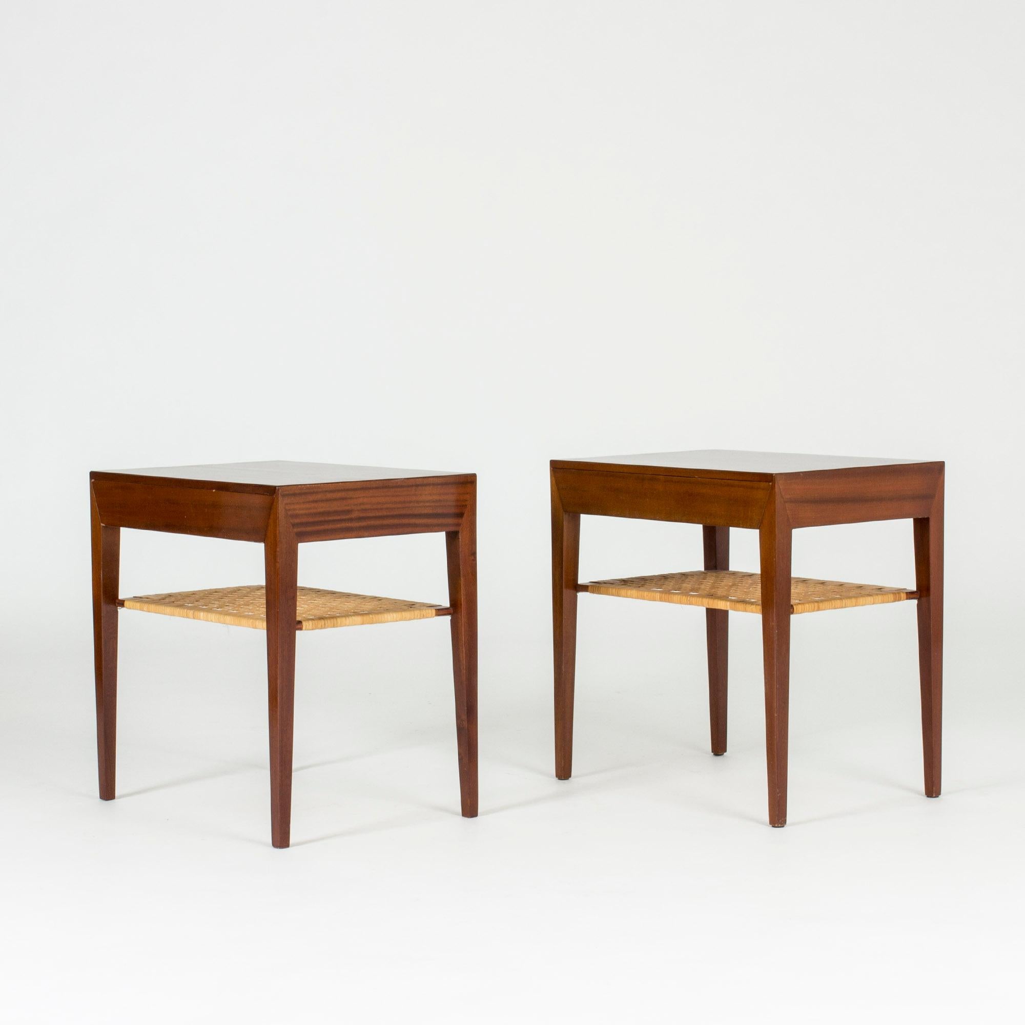 Pair of mahogany bedside tables by Severin Hansen with drawers and rattan shelves under the table tops. Severin Hansen’s characteristic diagonal, seamless joinery at the corners.