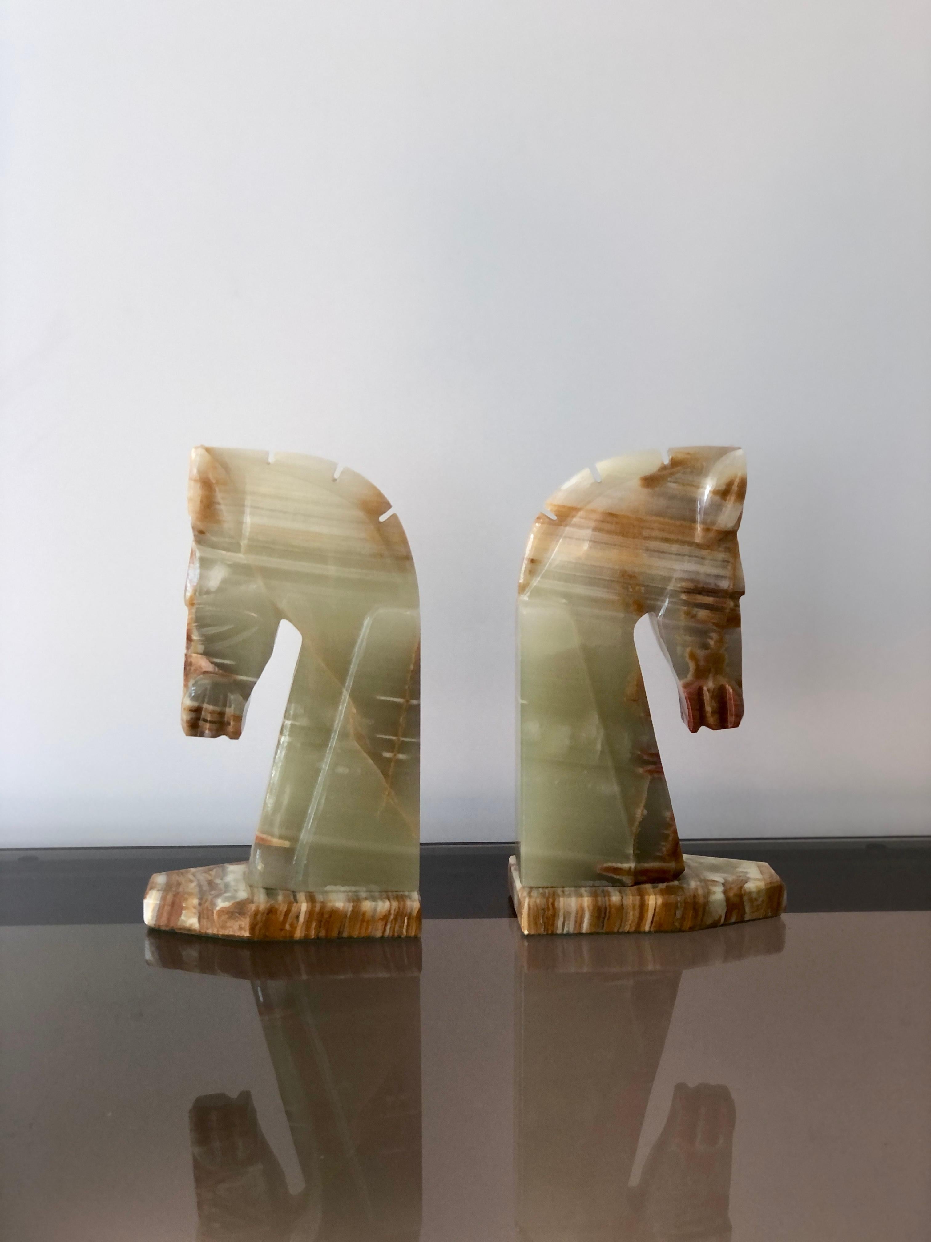 Pair of midcentury, circa 1970s, marble horse head bookends. well crafted with color honey cream and grey-green with amber and cream veined marble. Very stylish Etruscan horse profile bookends.